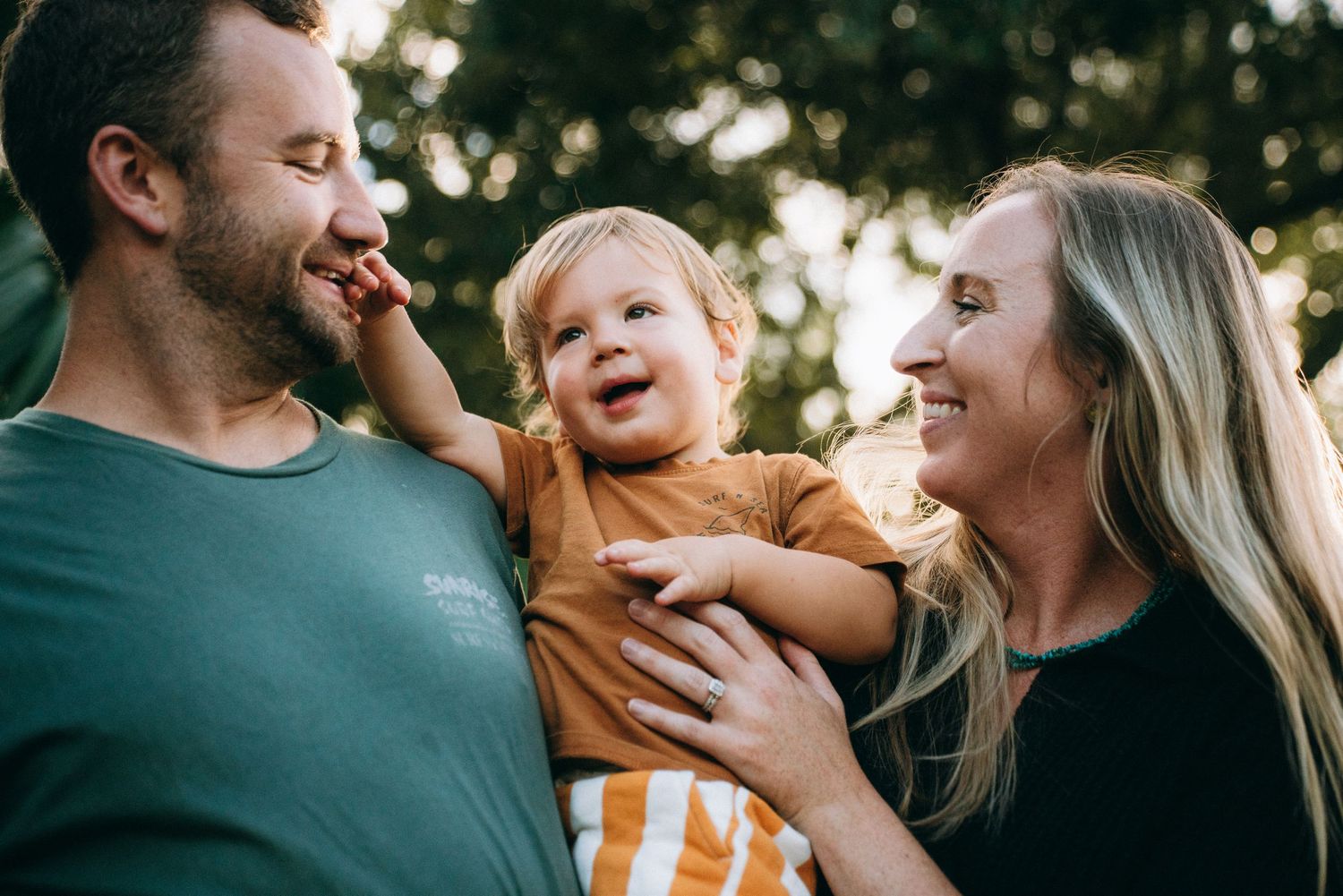 Natural family portrait session with genuine laughter and embraces.