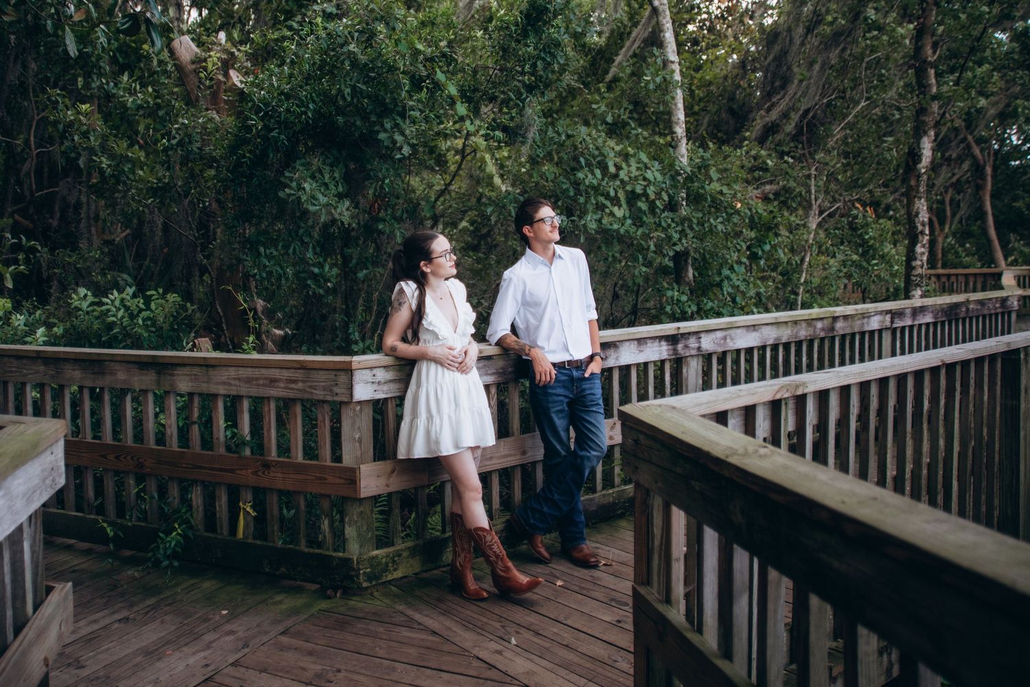 Wooden deck surrounded by lush greenery and trees at a historic property.
