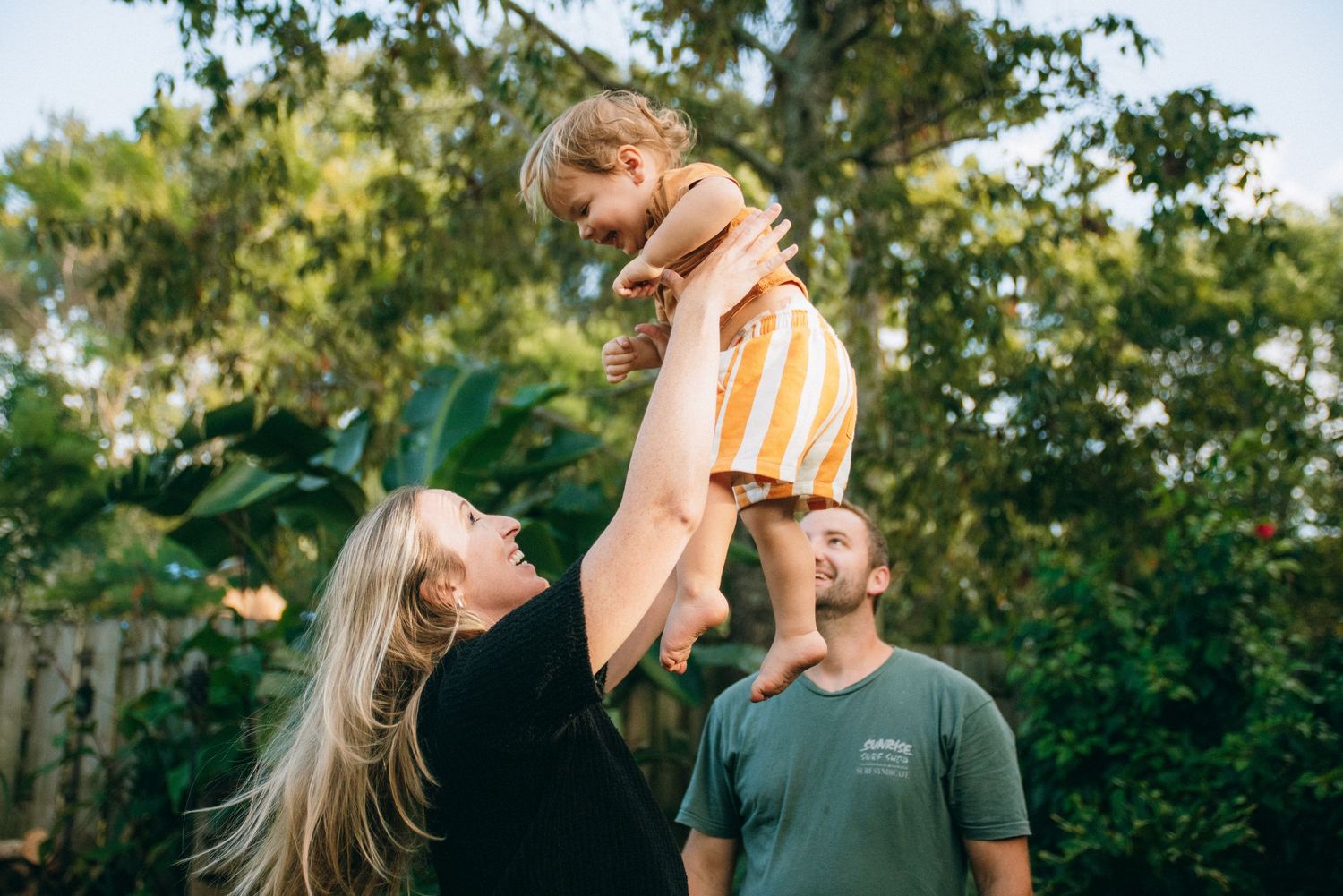 Series of candid family moments captured in a sunlit garden setting.