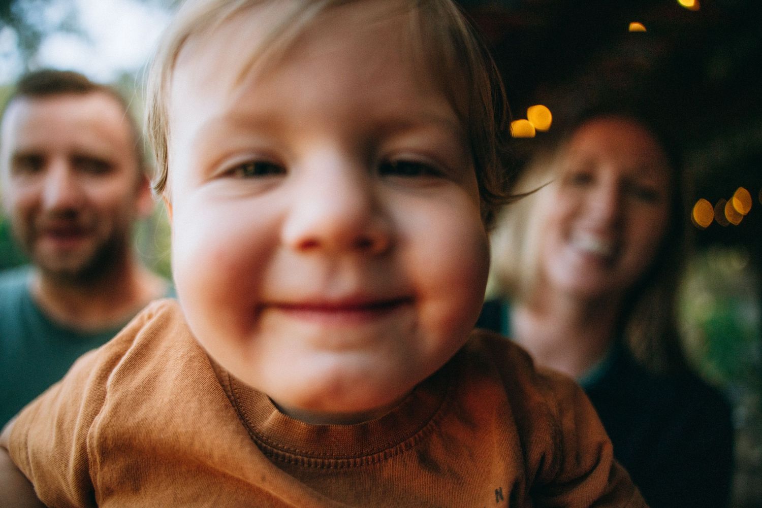 Sweet candid expressions captured during an outdoor family photoshoot.
