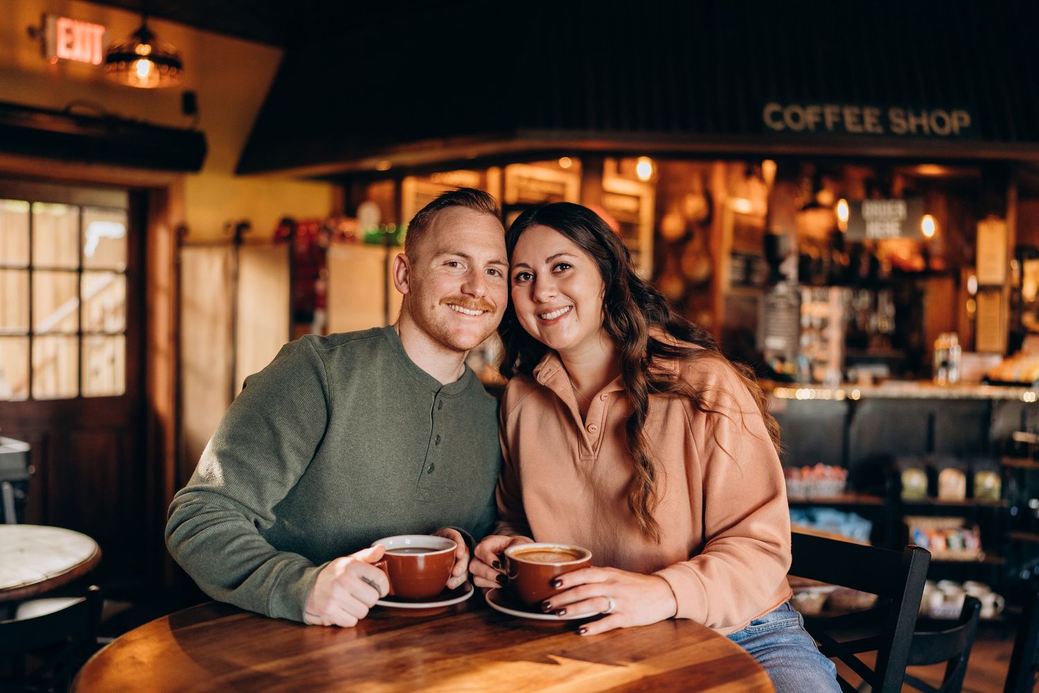 Cozy coffee shop interior with warm lighting and intimate seating.