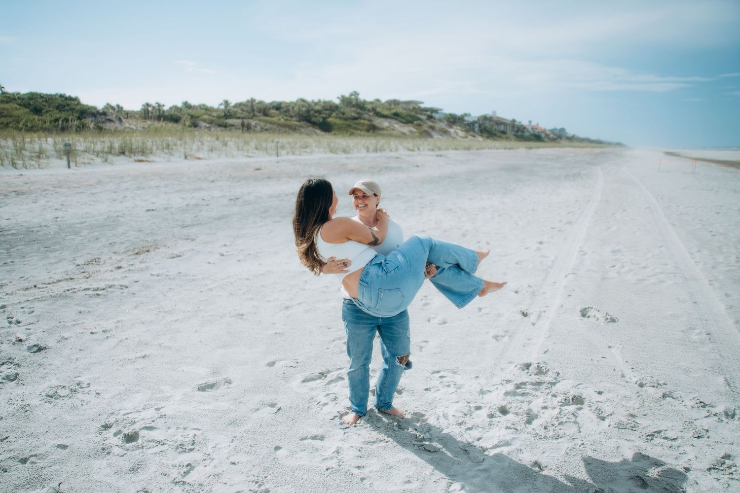 Candid beach photos of couple playing and having fun in the sand.