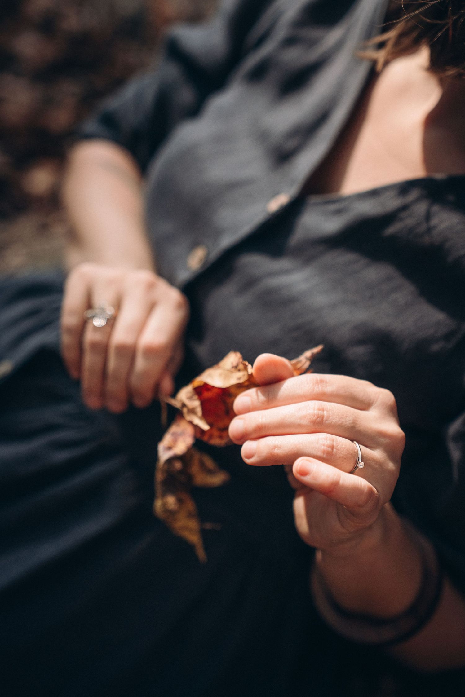 Close-up sequence of hands holding and sharing a chocolate chip cookie in moody lighting.