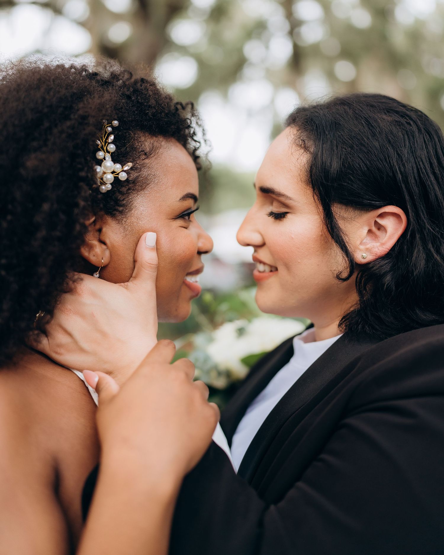 A tender moment shared between a couple during their outdoor wedding celebration.