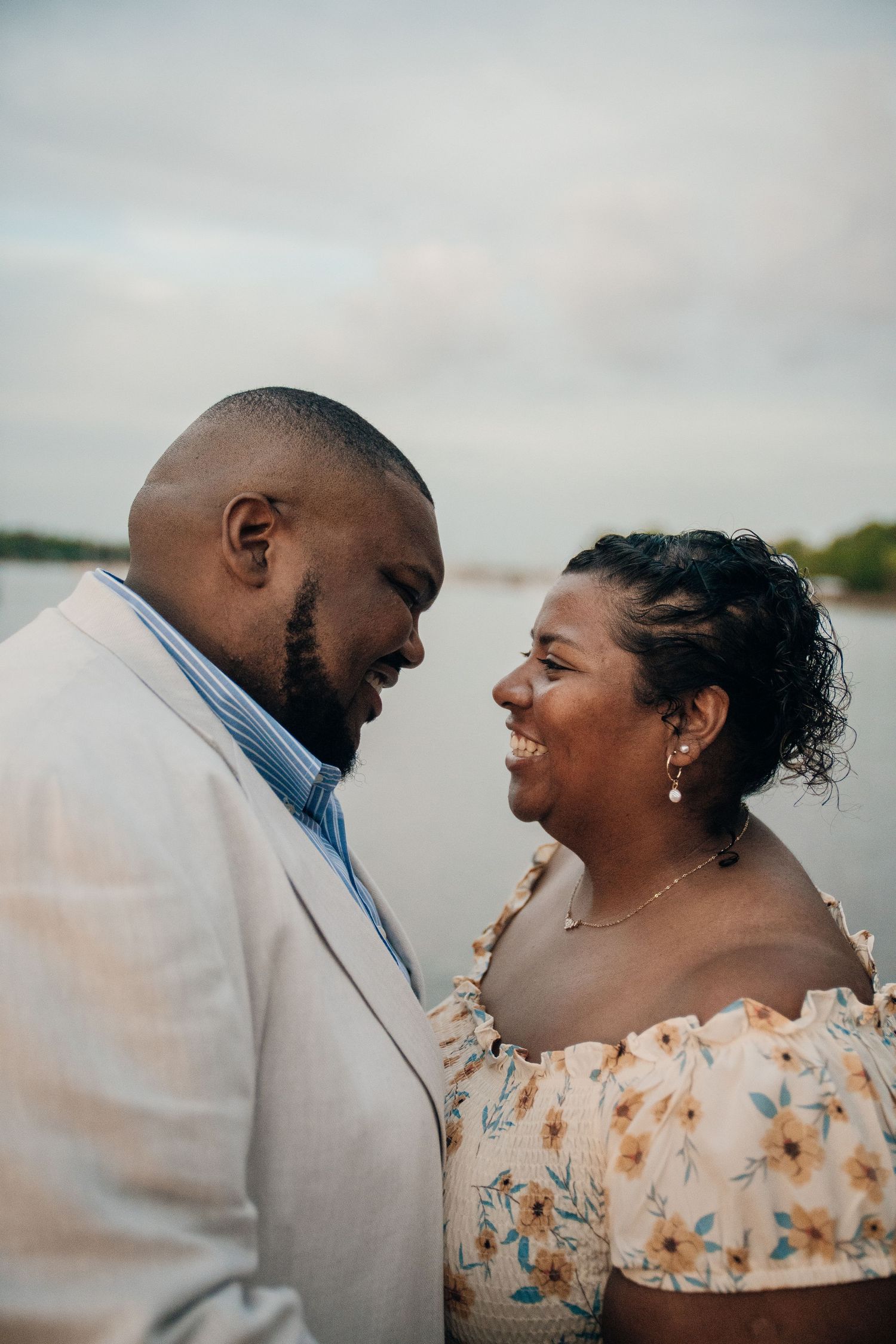 Close-up romantic portraits on a waterfront during sunset.