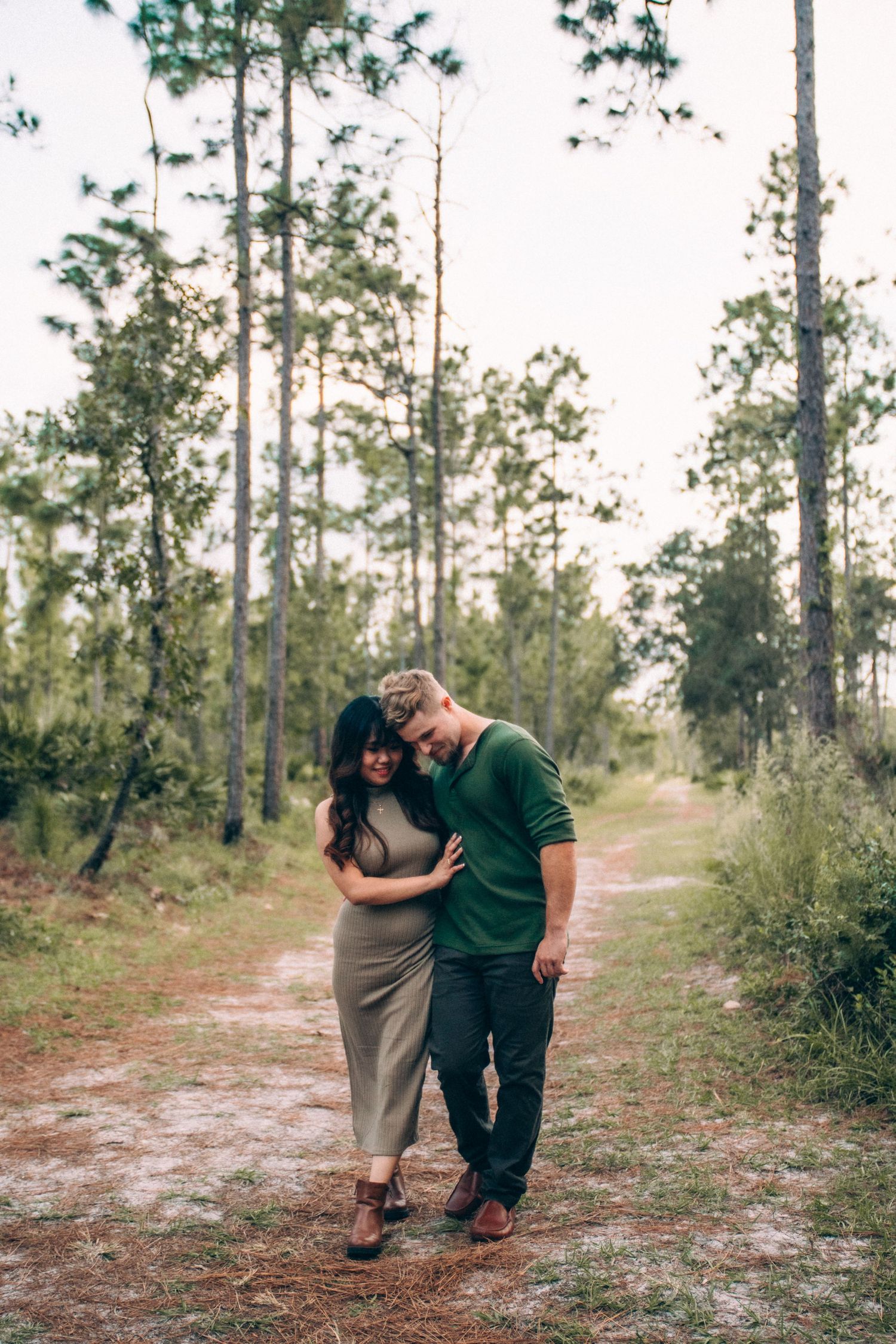 Romantic sequence of photos showing tender moments between two people on a forest path.