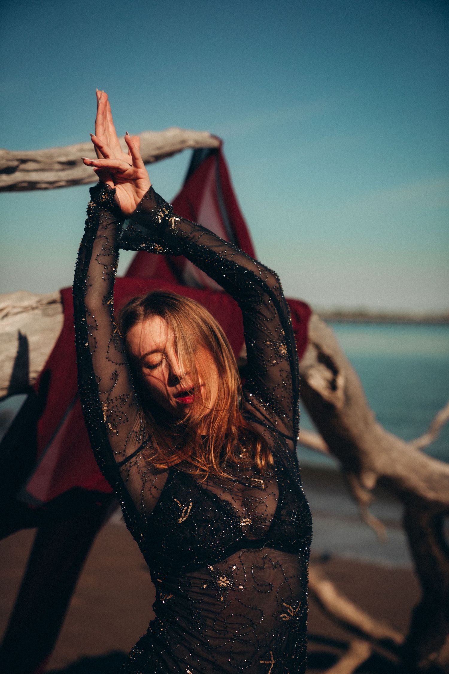 A series of artistic shots showing movement and dance against a beach backdrop at sunset.