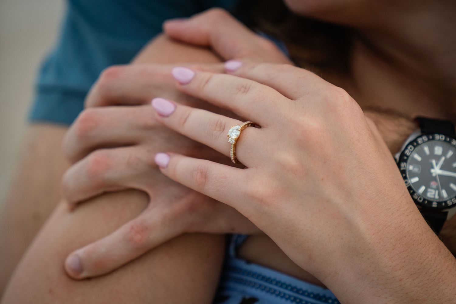 A close-up shot of hands exchanging wedding rings during a marriage ceremony.