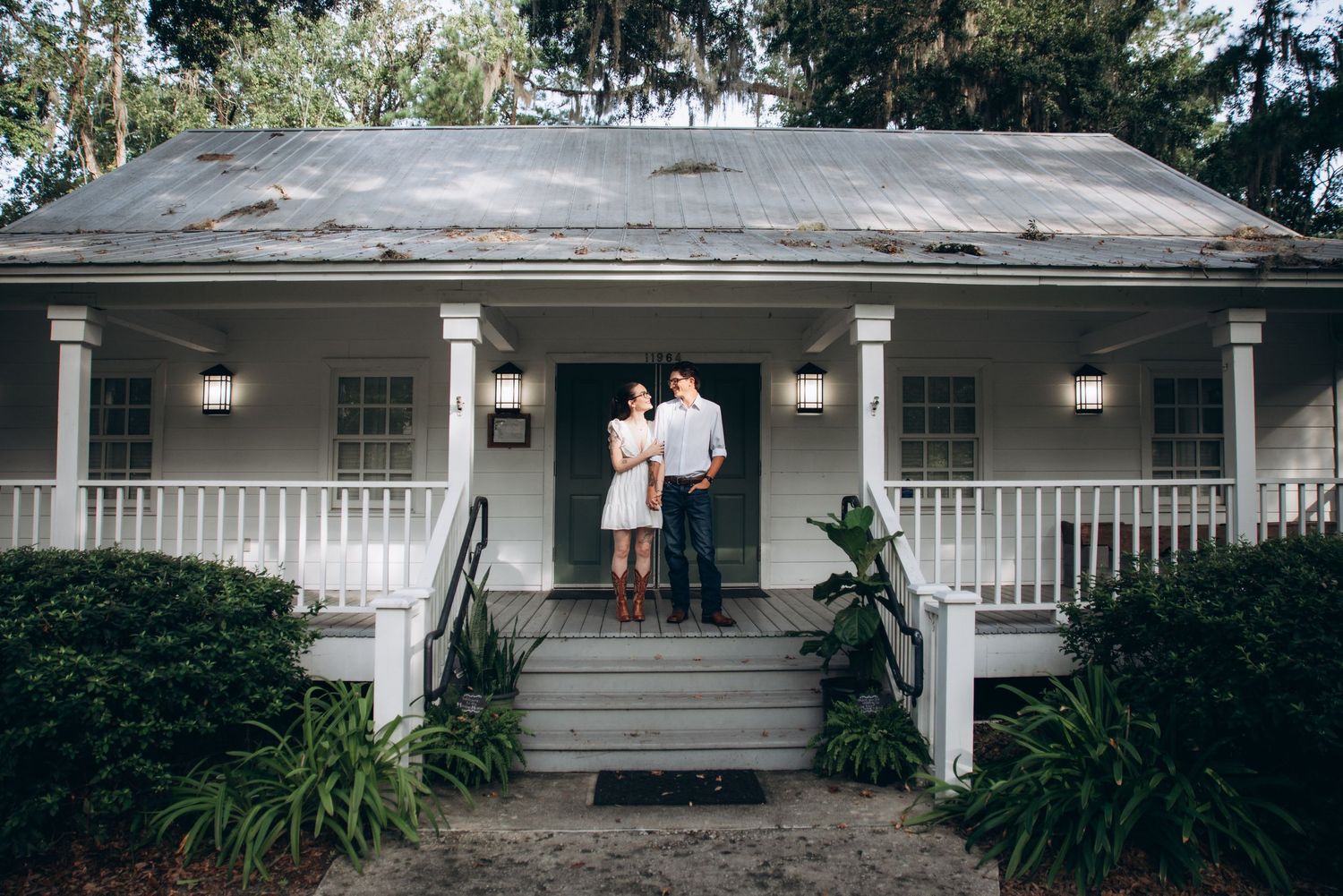 A series of connected photos showing the exterior of a modern ranch-style house with a white porch and landscaping.