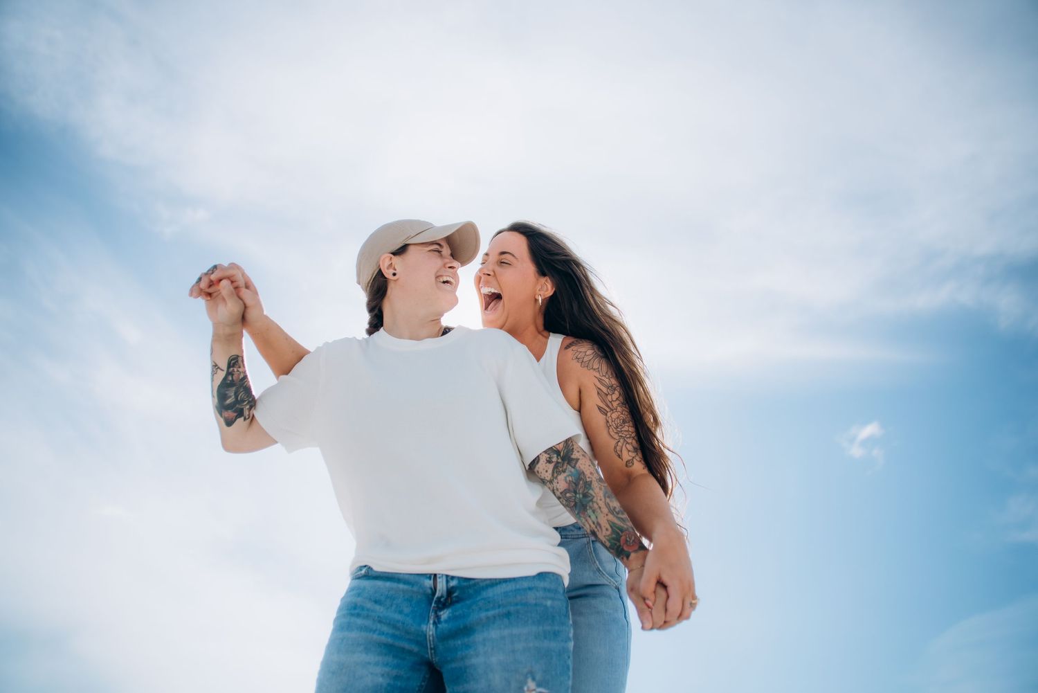 Candid beach photos of couple enjoying romantic moments together.
