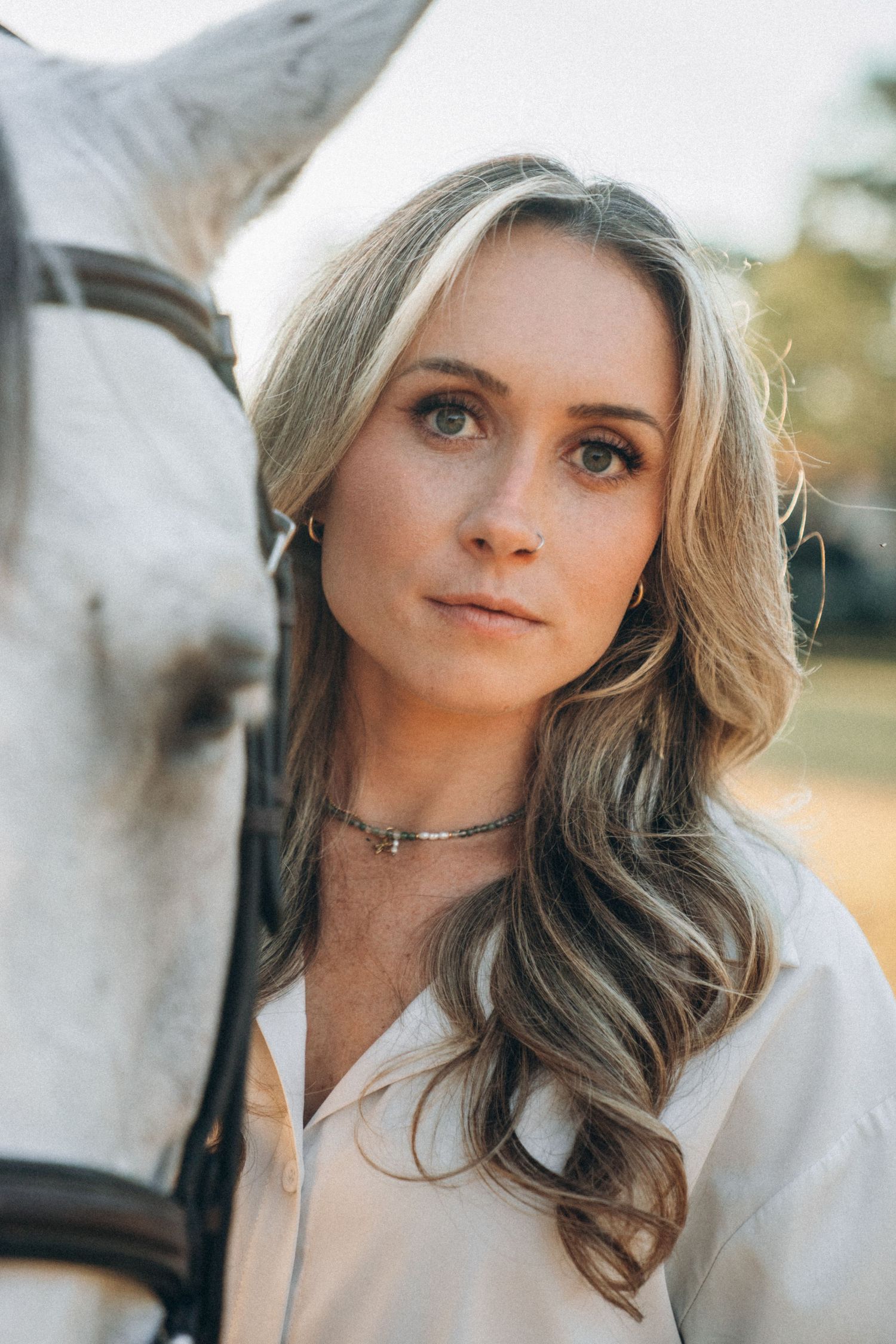 Ethereal portrait series with soft backlighting and natural outdoor setting.