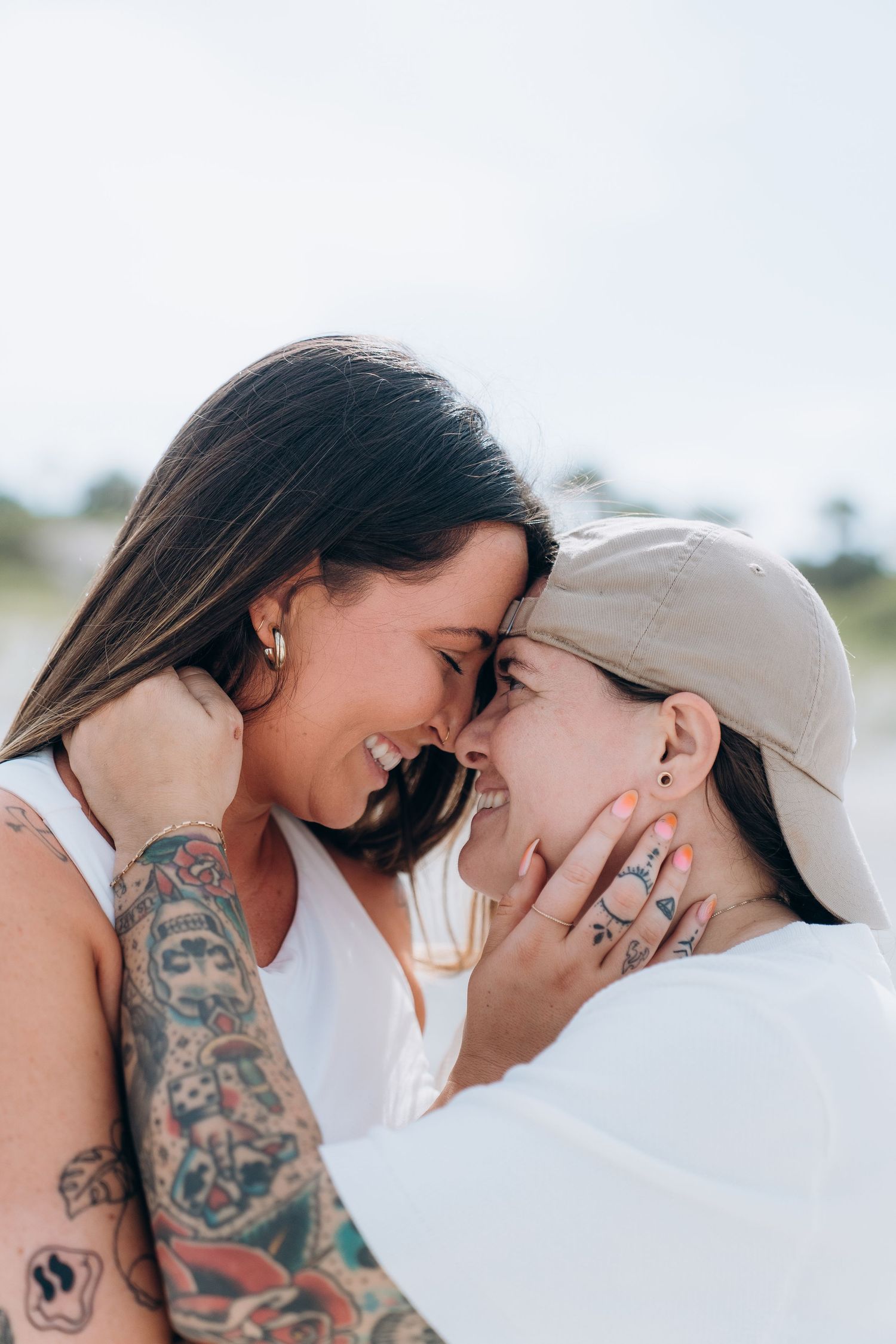 Intimate close-up shots of couple sharing tender moments on sunny beach.