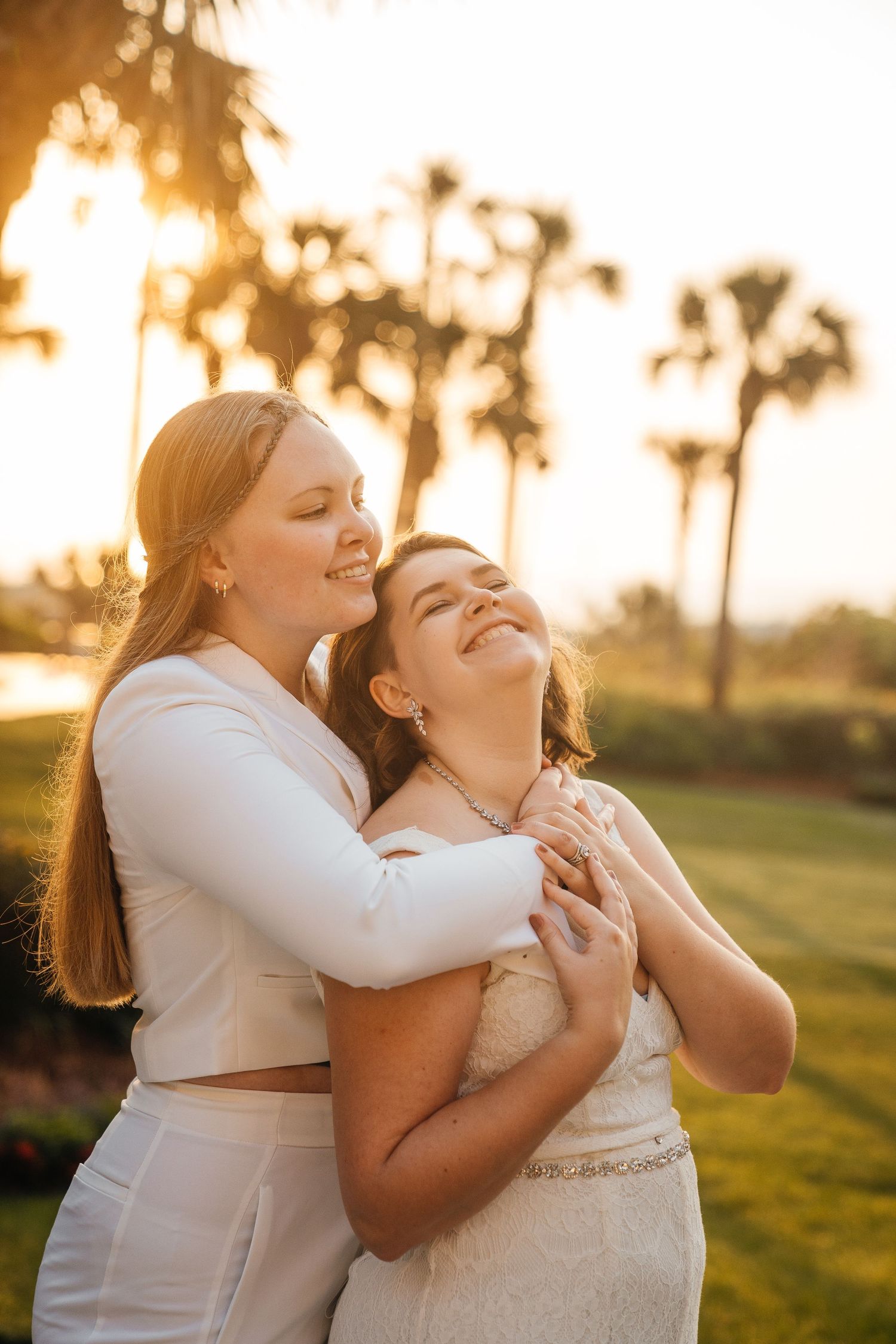 A sunset wedding photoshoot capturing intimate moments between a couple in white dresses.