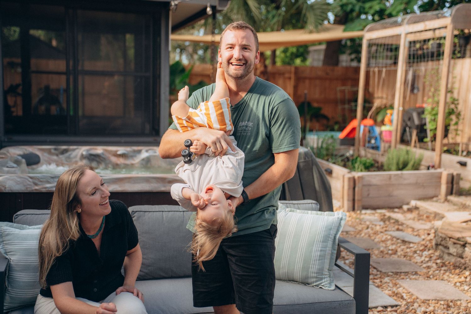 Family shares joyful moments together in their backyard on a sunny afternoon.