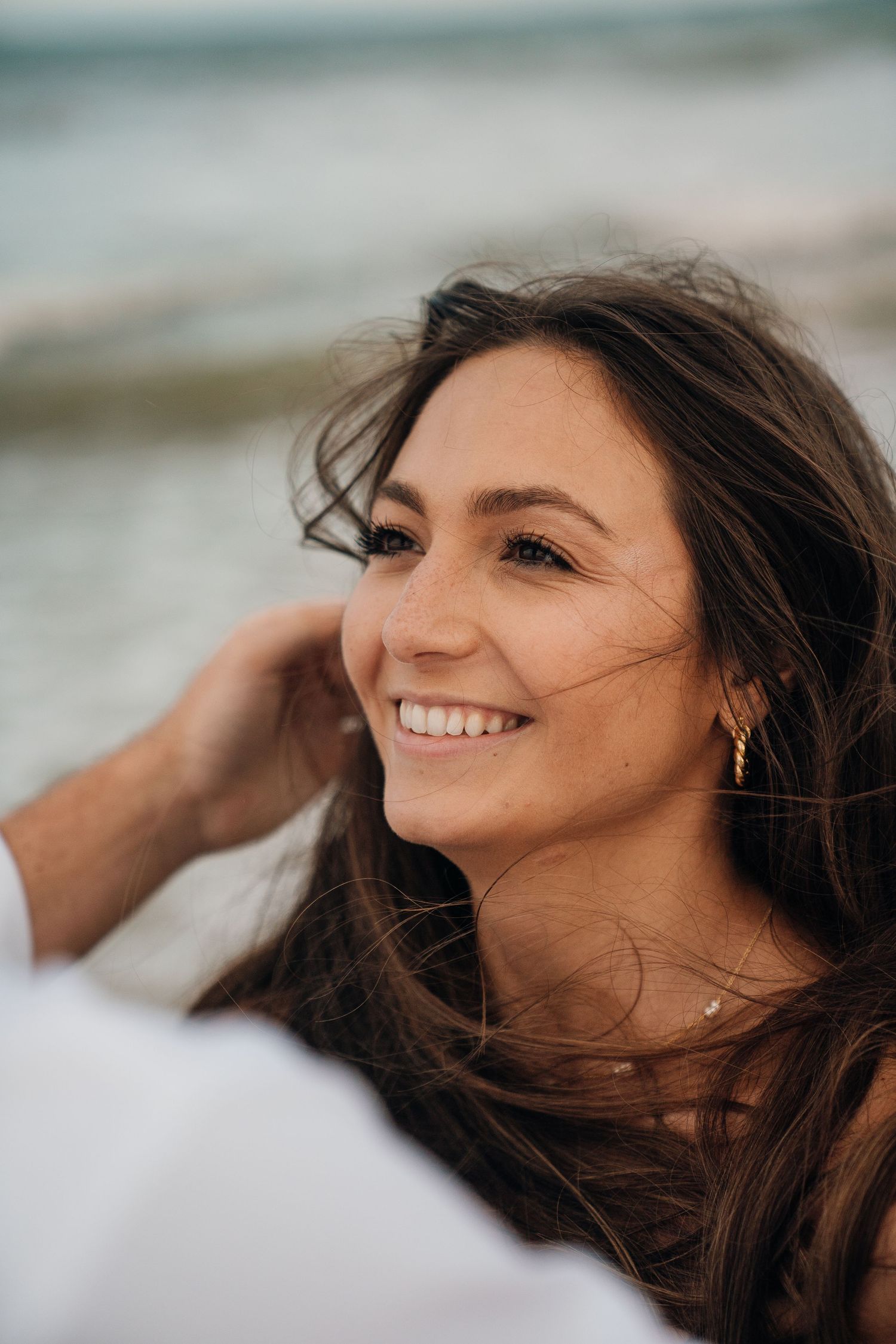 A series of candid portraits showing joyful expressions and windswept hair against a blurred background.