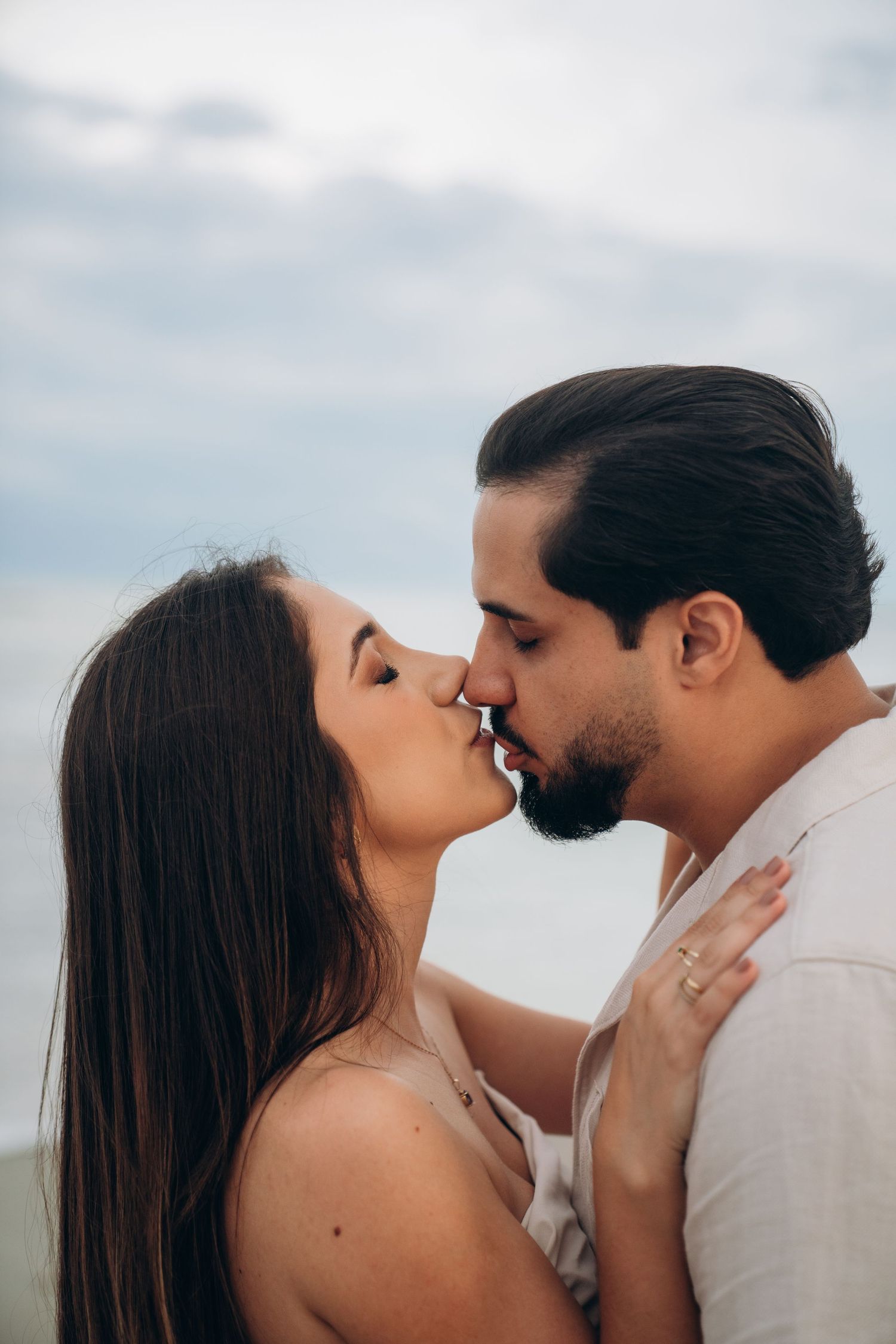 Intimate close-up of a couple sharing a romantic moment on the beach.