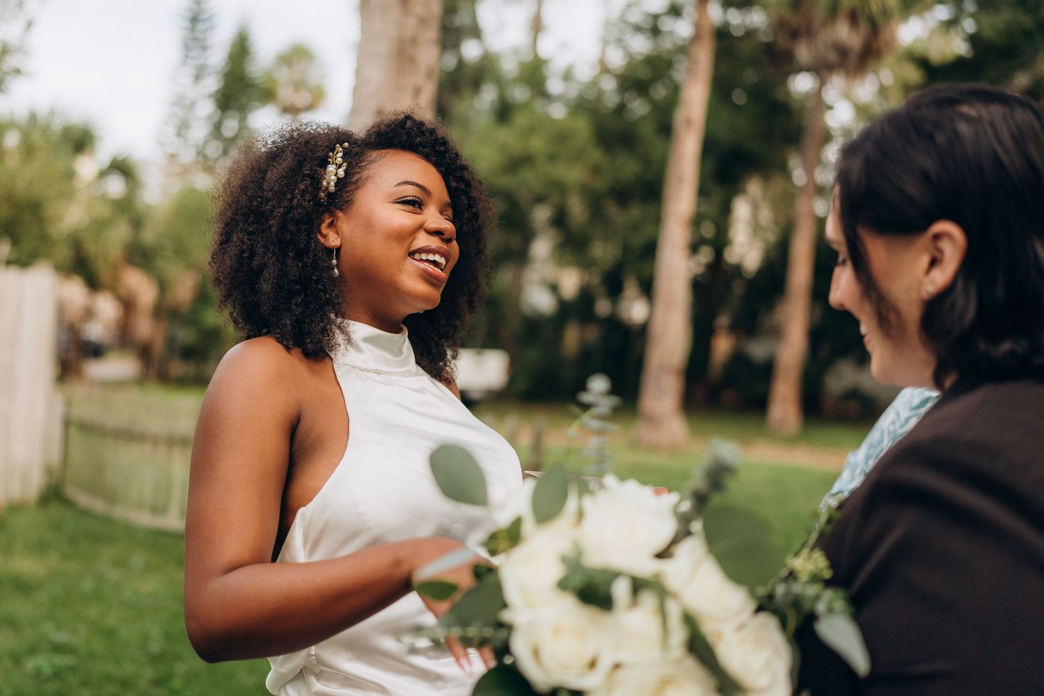 A joyful moment shared between two people during an outdoor wedding celebration.