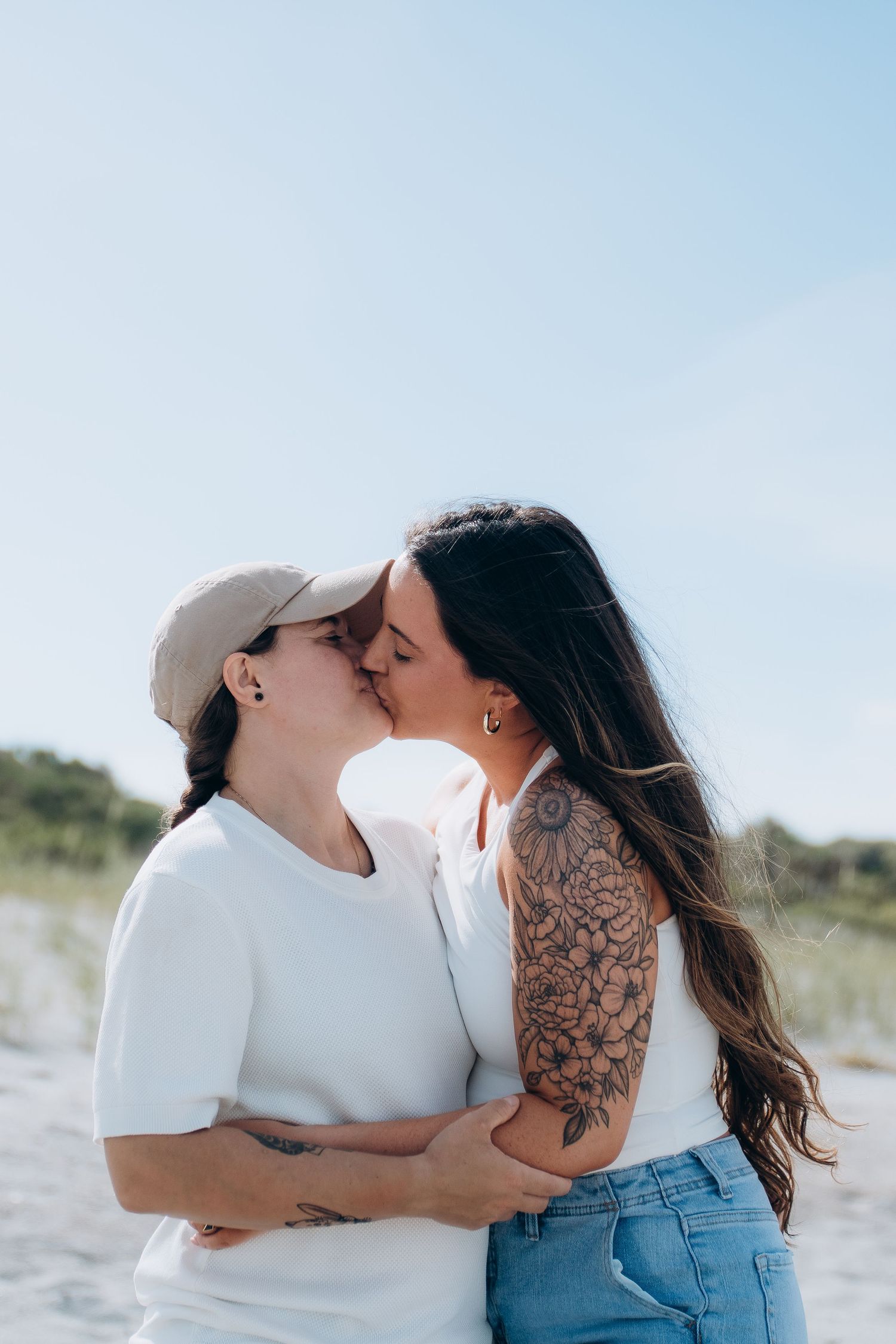 Intimate beach portraits showing tender moments between couple.