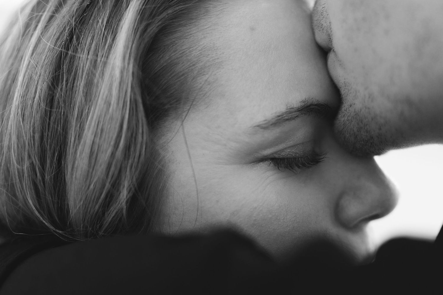 Intimate black and white close-up portrait showing emotional connection.