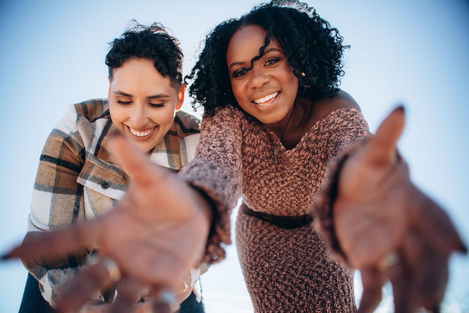 Close-up shots of couple sharing intimate moments against a bright blue sky background.
