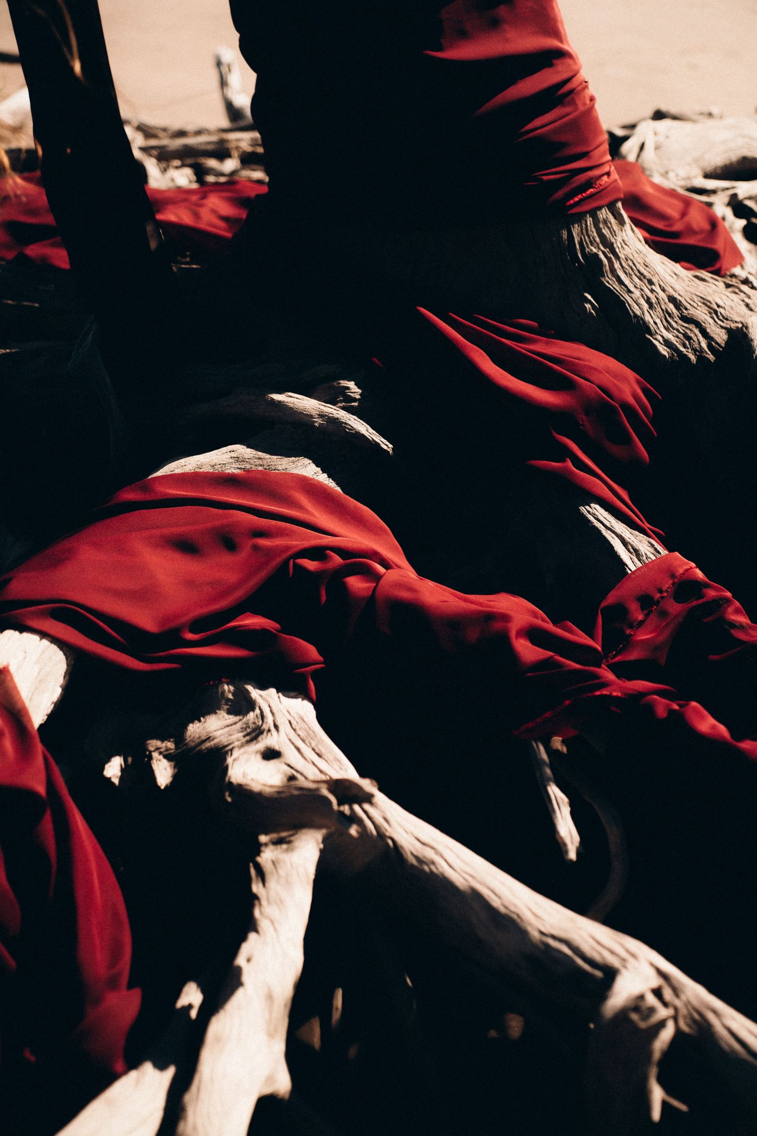 Abstract composition of red fabric and dark shadows creating dramatic contrast patterns.