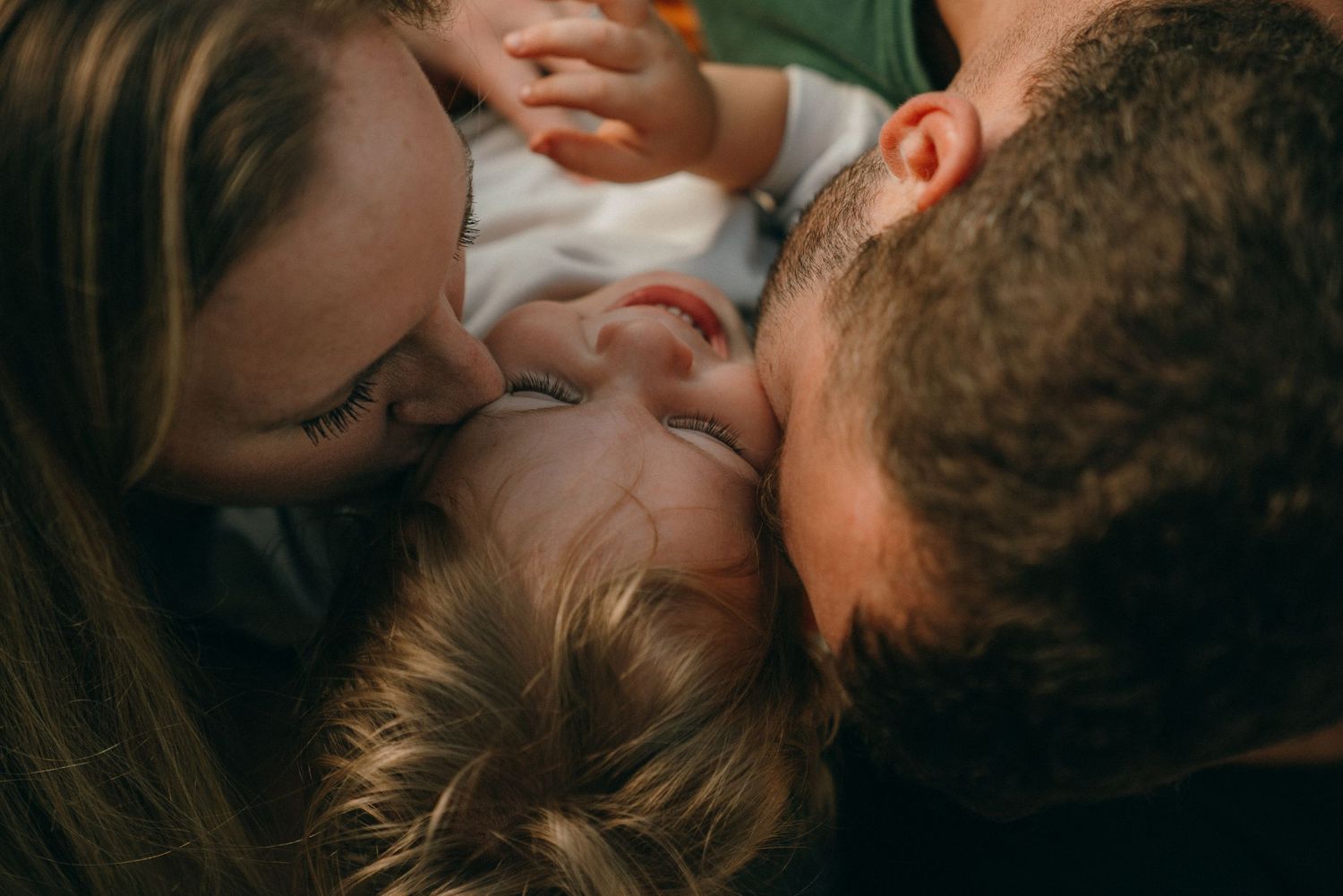 Close-up portraits capturing tender family interactions and expressions.