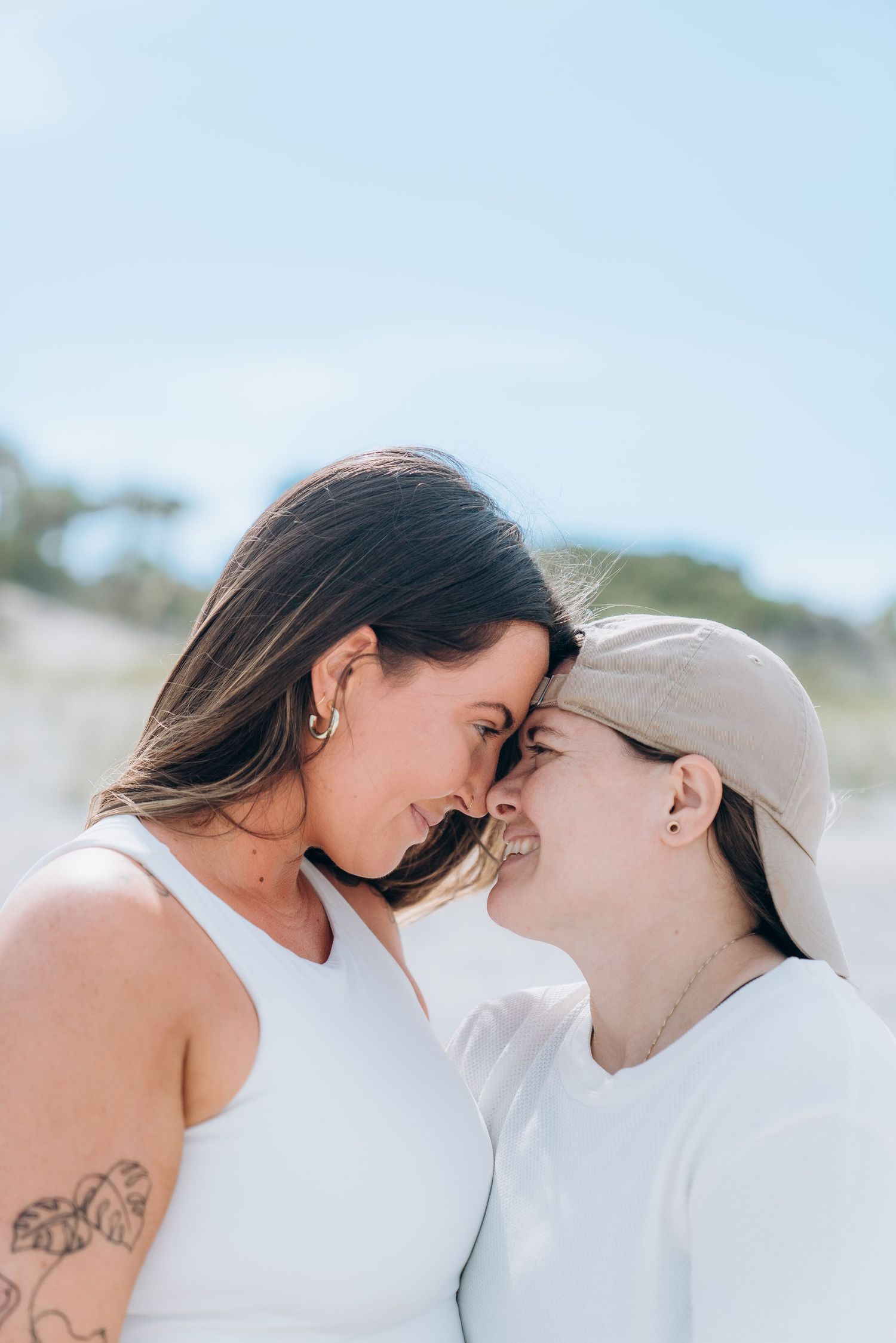 Close-up romantic beach portraits showing tender moments between couple.