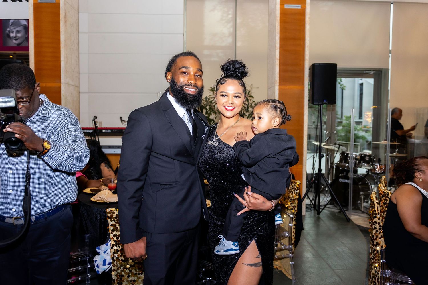 A family group poses together during a formal celebration in a modern venue setting.
