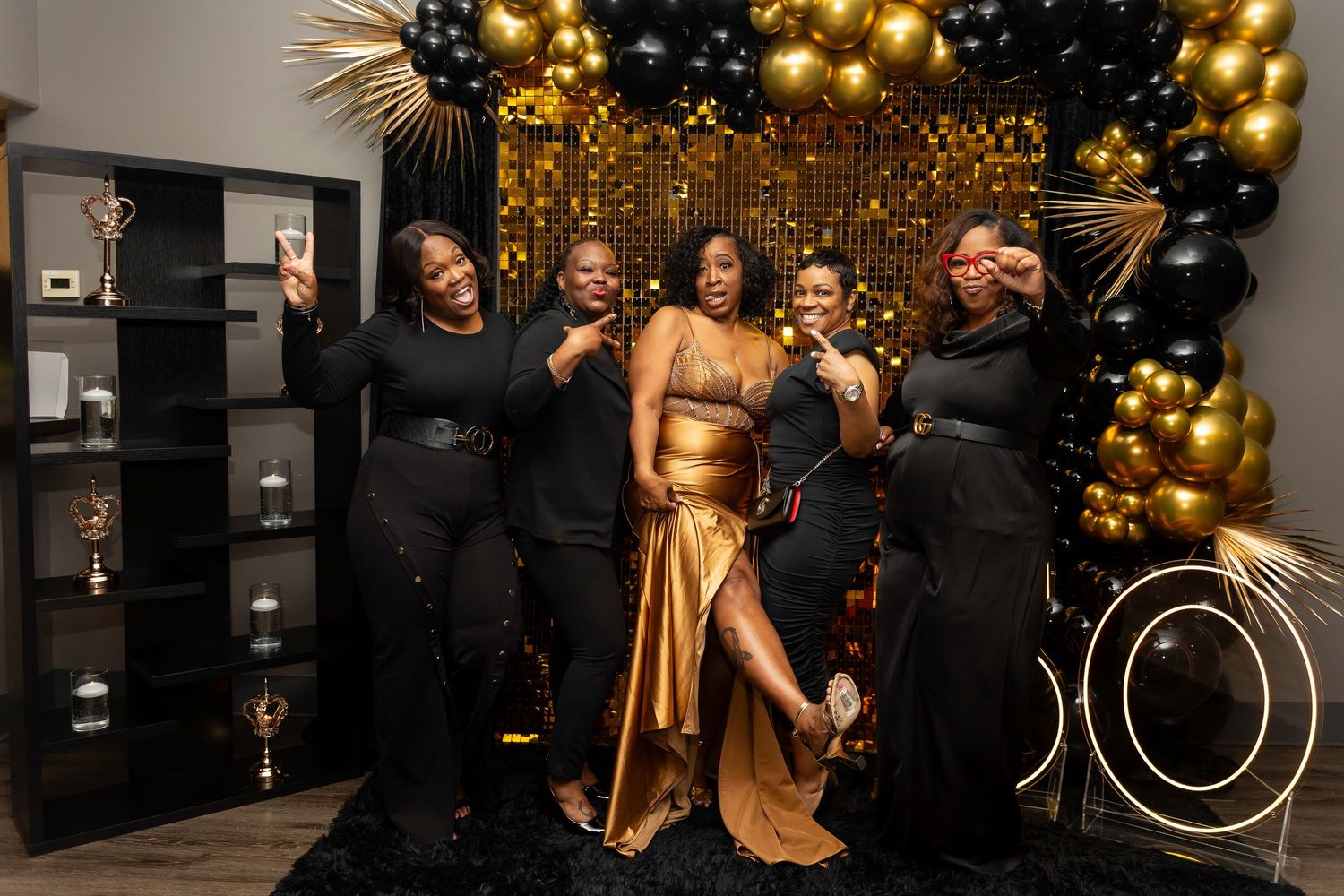 Formal event space decorated with elegant gold balloons and ambient lighting.