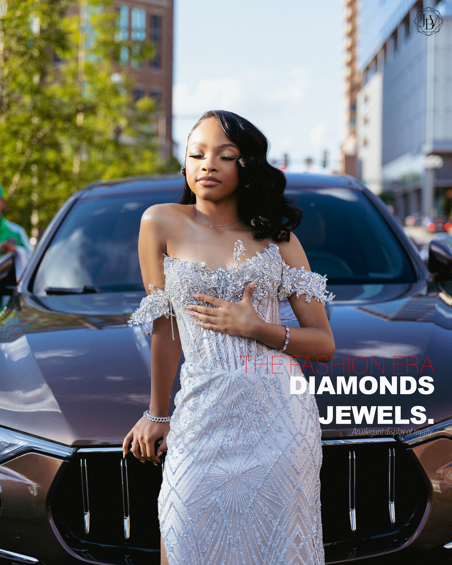 Woman in beaded off-shoulder gown poses by luxury car with Diamonds Jewels branding in urban setting.