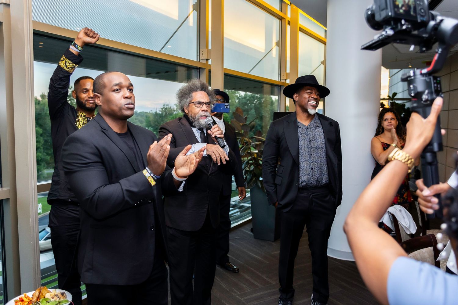 A lively gathering of guests in formal attire interacting at an upscale event venue.