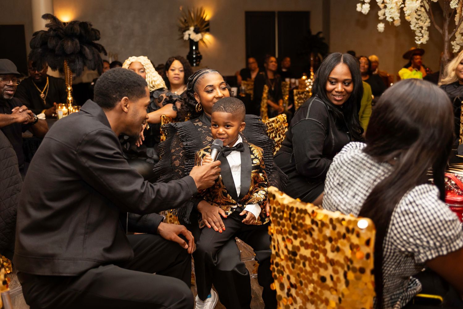 Guests enjoying a lively moment at an upscale evening celebration with festive decorations.