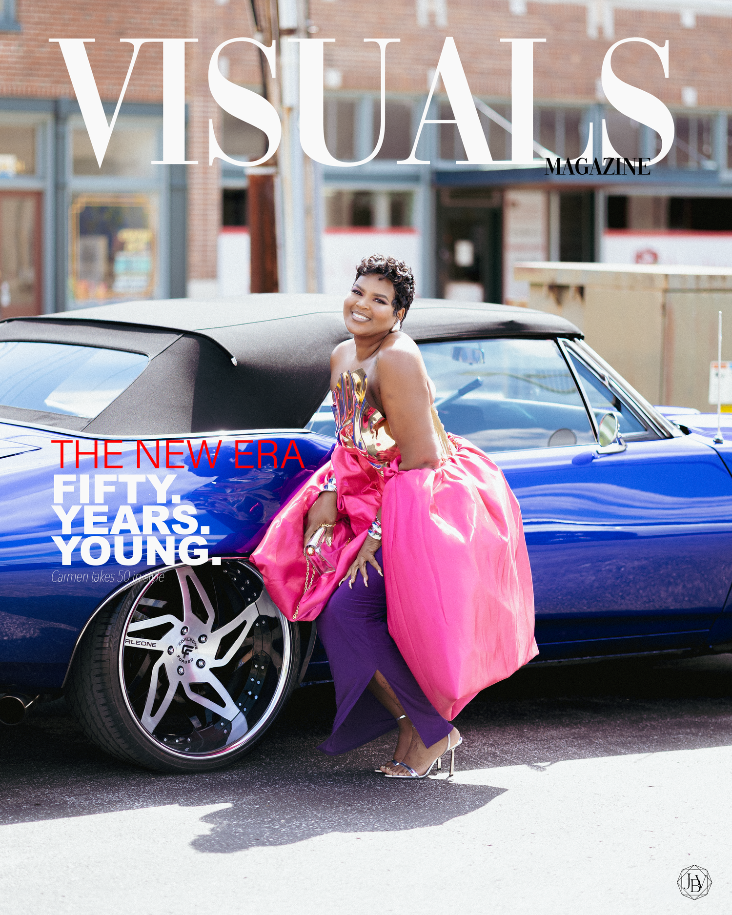 Woman in pink ball gown poses by blue classic car on Visuals Magazine cover, headline reads Fifty Years Young.