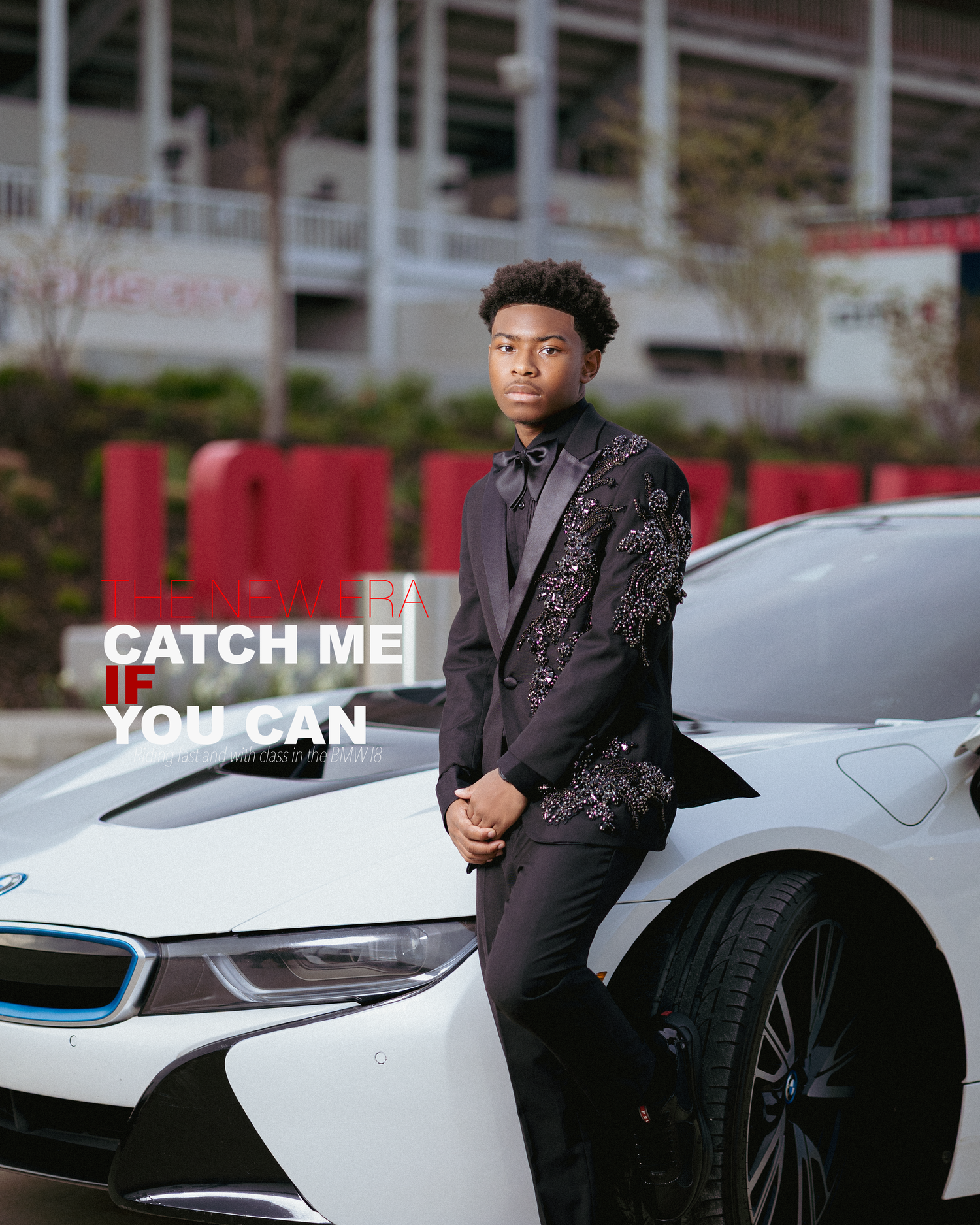 Young man in embellished black suit leaning on white BMW i8 with 'Catch Me If You Can' text overlay.