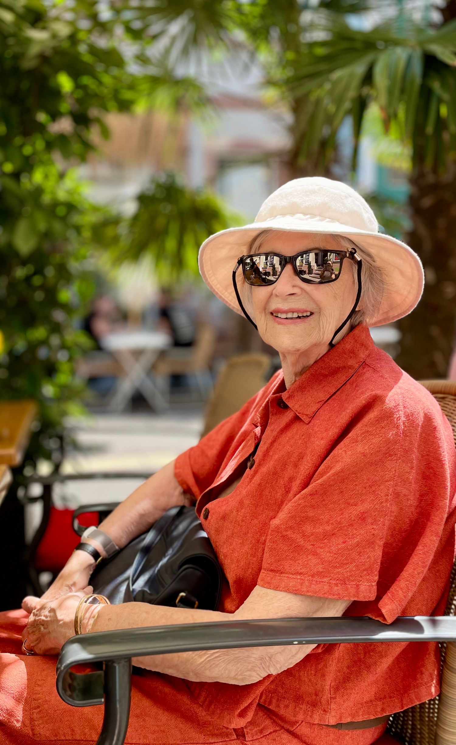 Grandmother posing outside a restaurant in summer, Karlsruhe, Germany