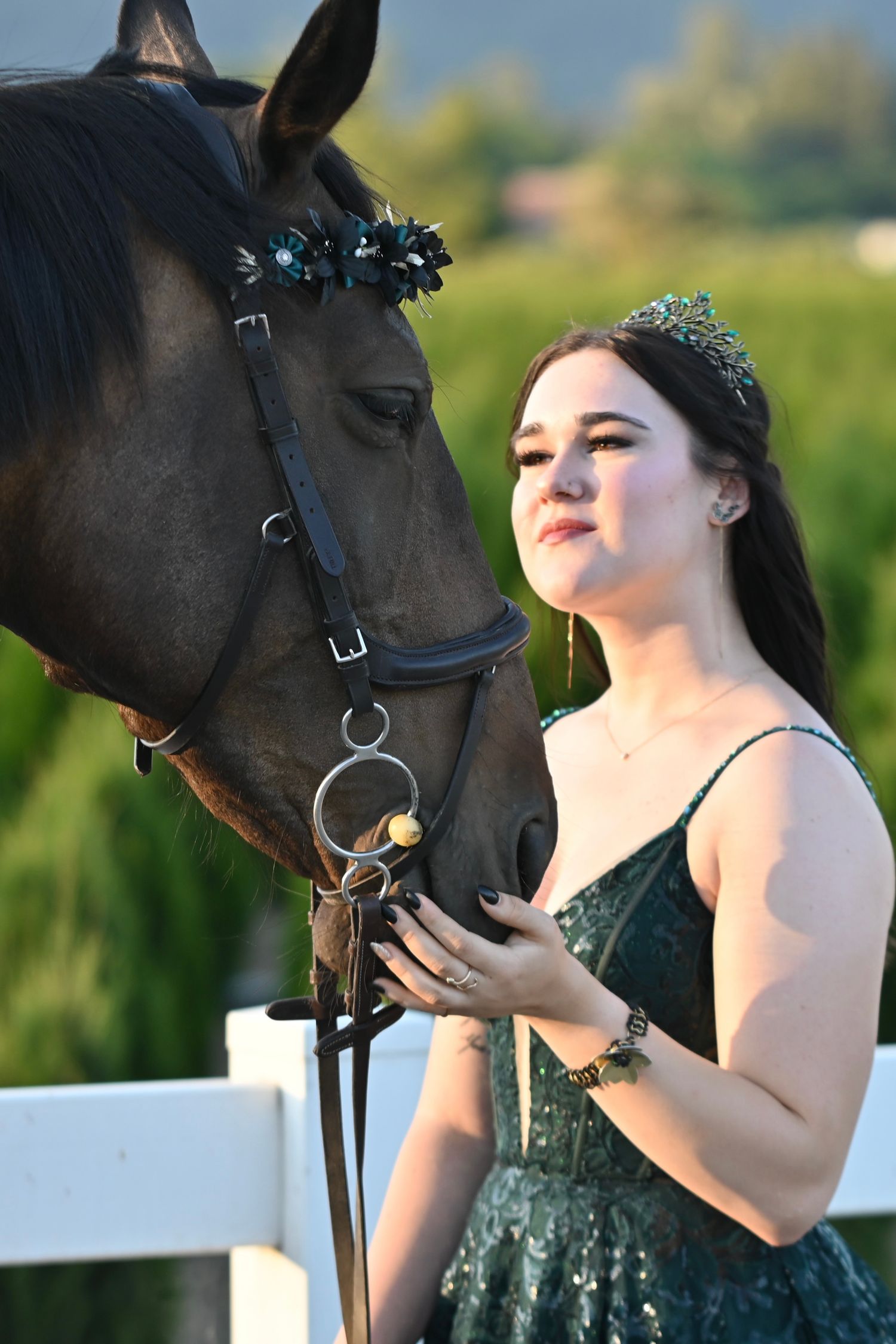 Female in grad dress looking at horse, graduation, equine