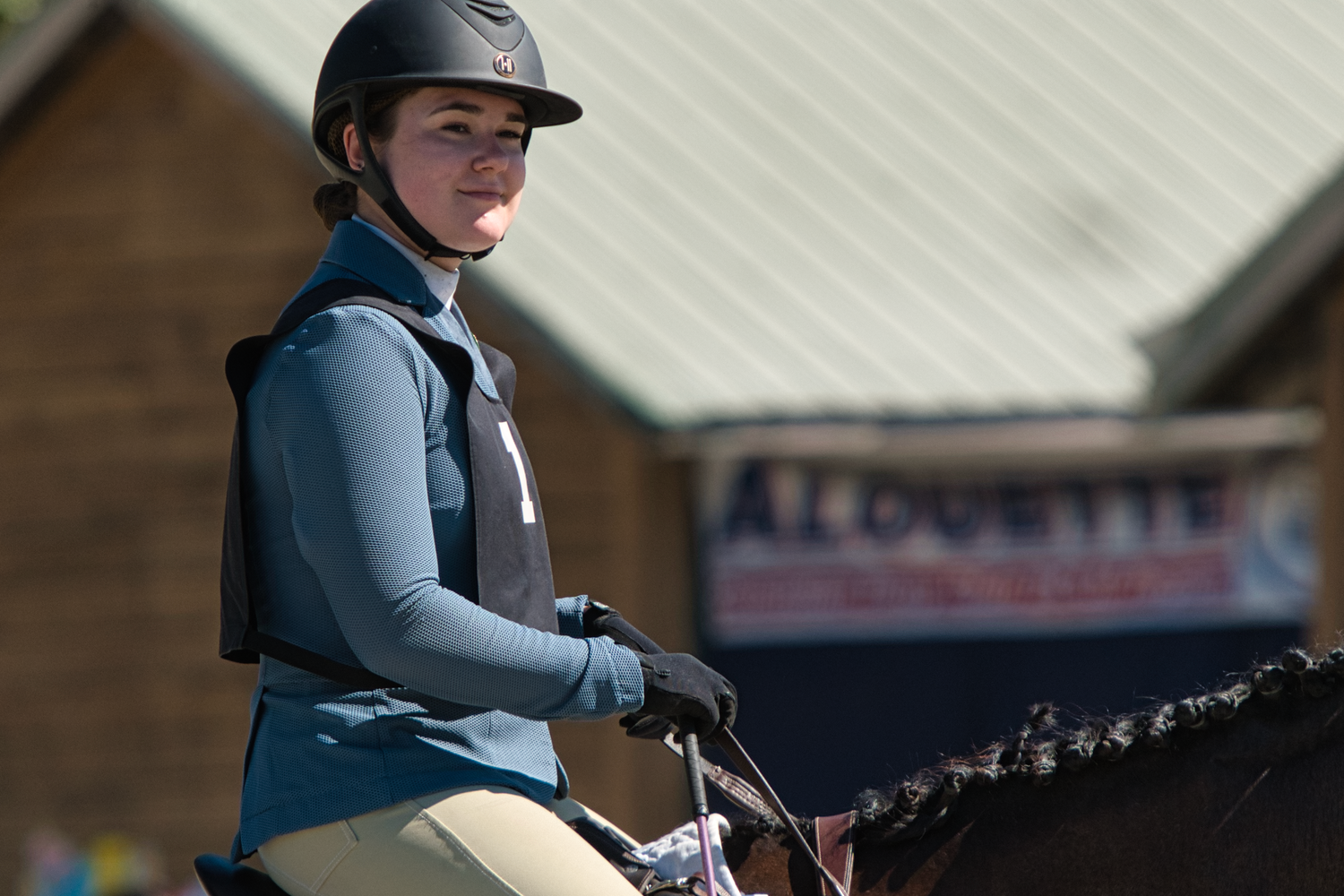Girl dressed in show jumping outfit with pinny, sitting on horse,  waiting for her turn to jump, Pony Club, equine, equestrian, Maple Ridge