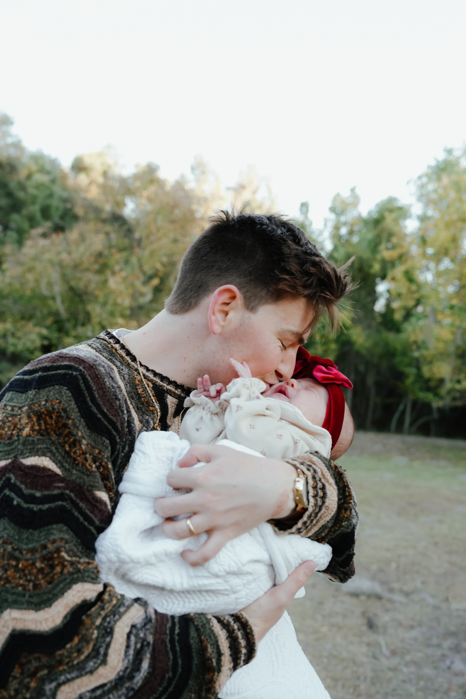 Dad Holding Newborn Baby in Louisiana