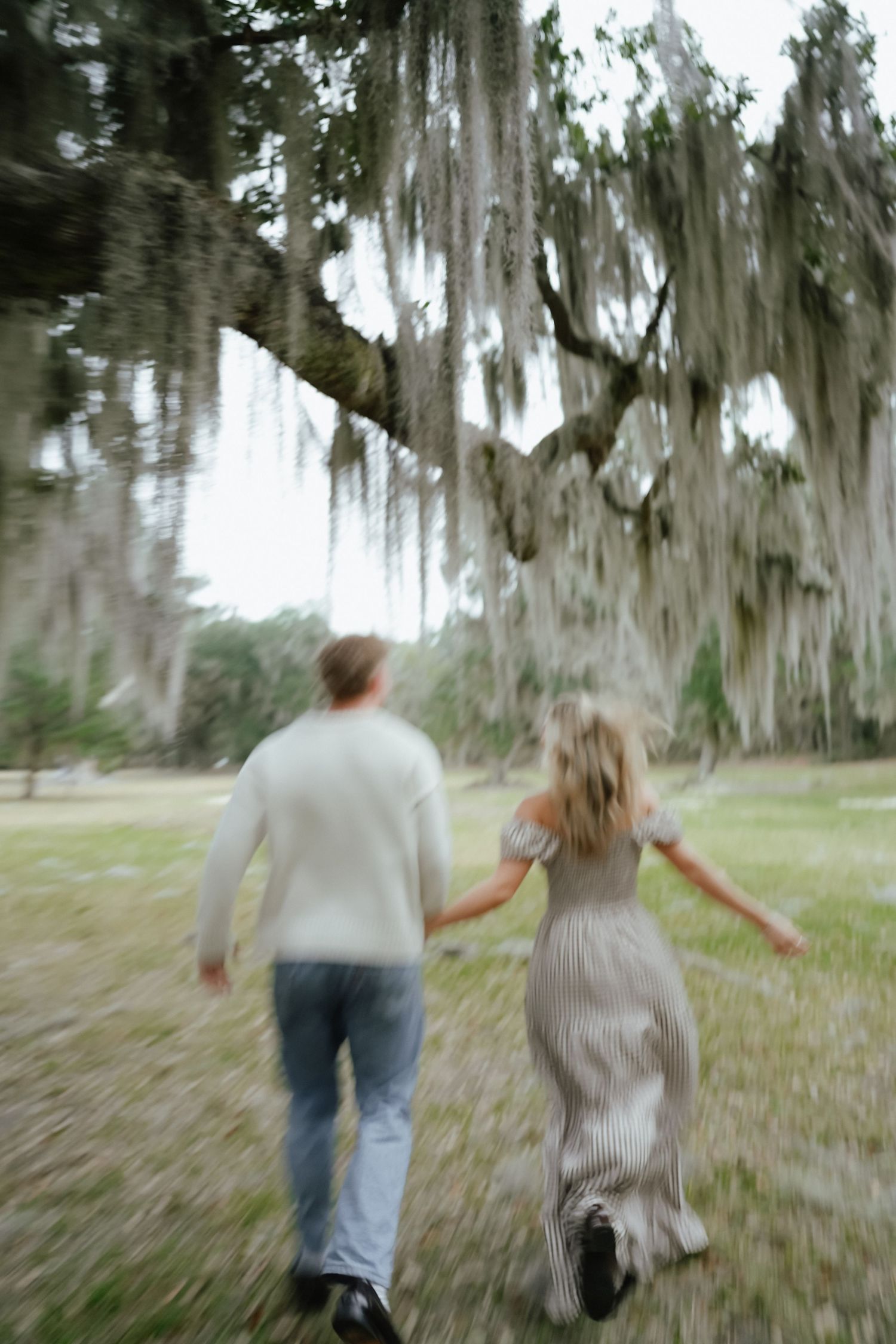 Couple Holding Hands and Running in Louisiana Field