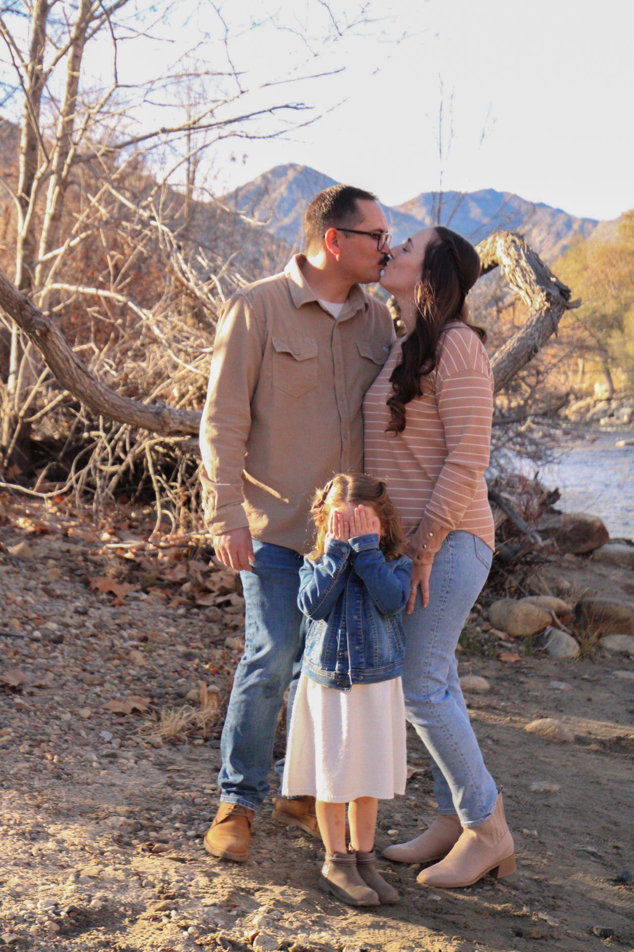 silly photo of mom and dad kissing while daughter covering her eyes
Kern County Photography
Tori Marie Photos
Family Photography