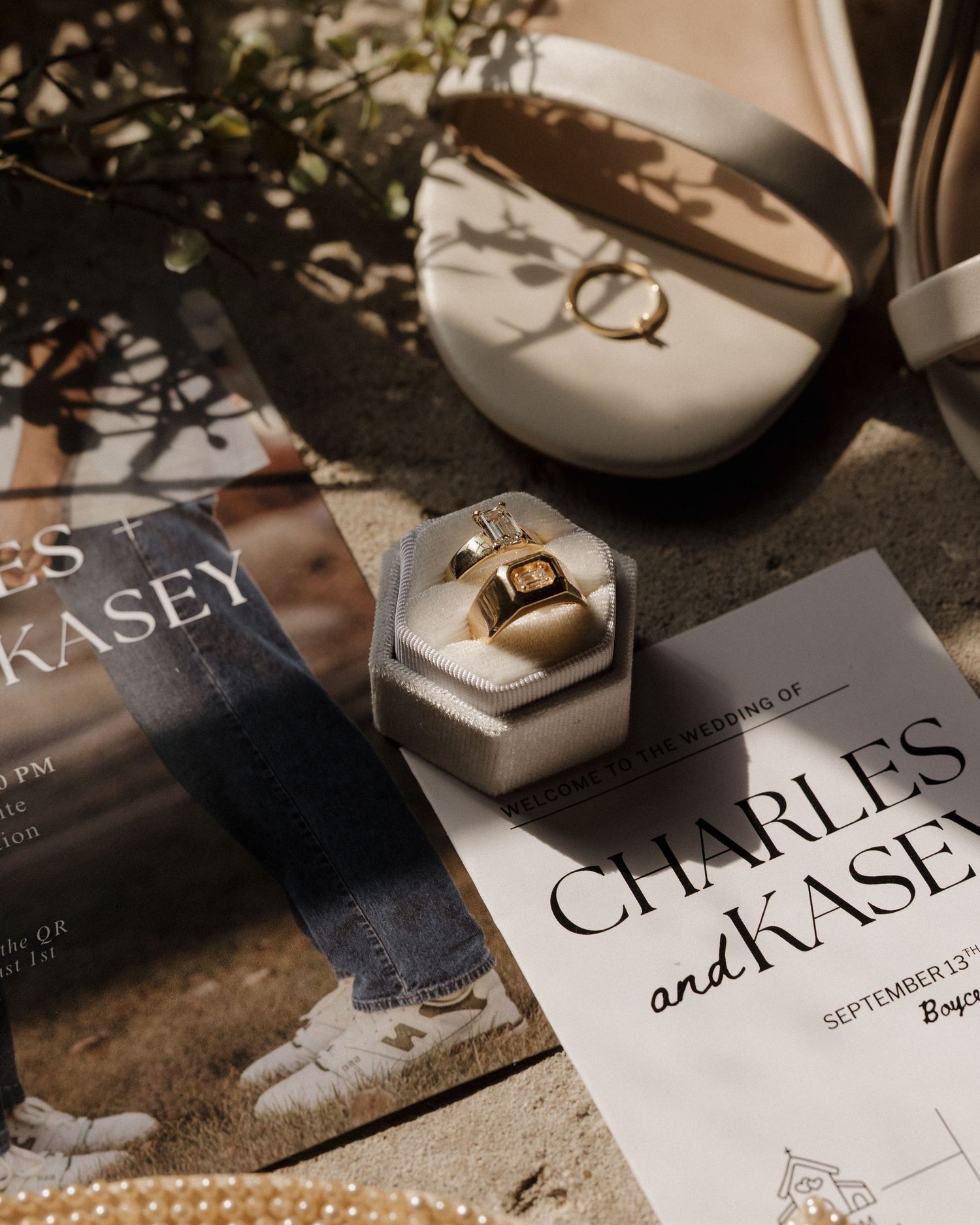 Wedding stationery and invitation cards laid out on a dark surface with elegant calligraphy and typography details.