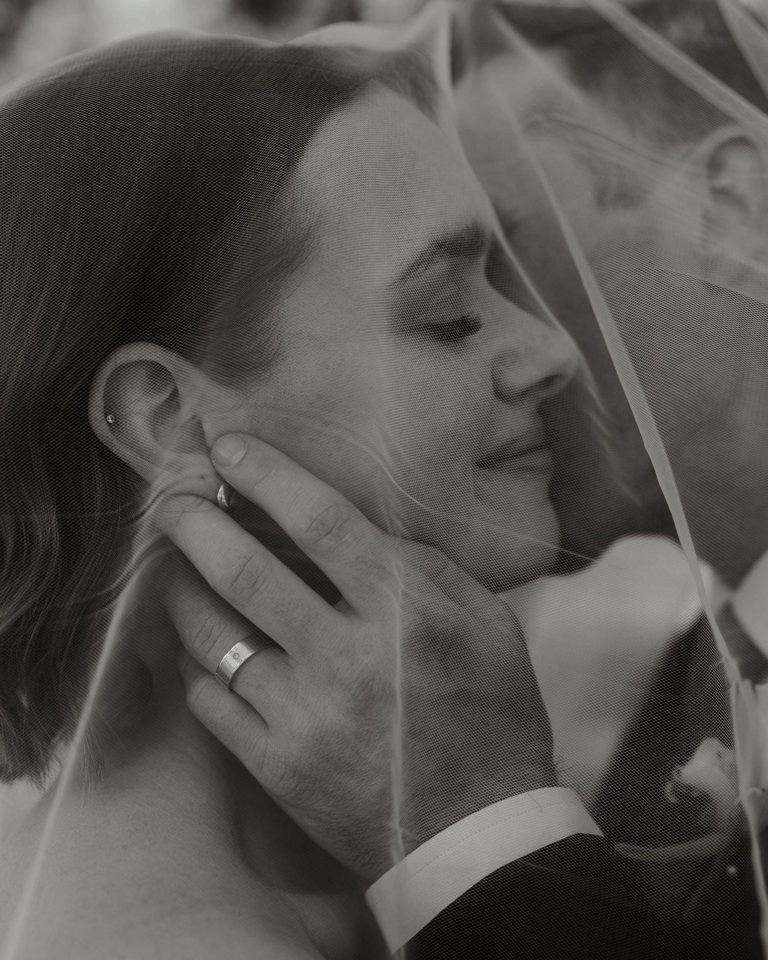 A black and white artistic photo series showing a couple in an intimate embrace with smoke swirling around them.
