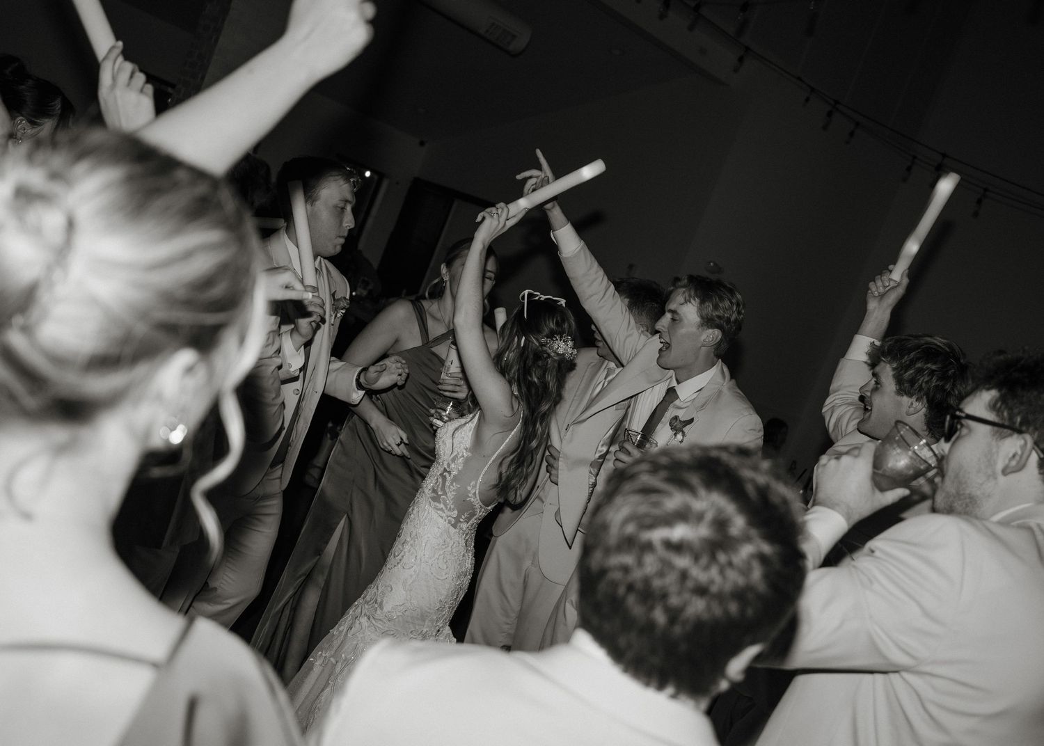 A black and white photo montage shows people dancing and celebrating at what appears to be a lively party or nightclub.