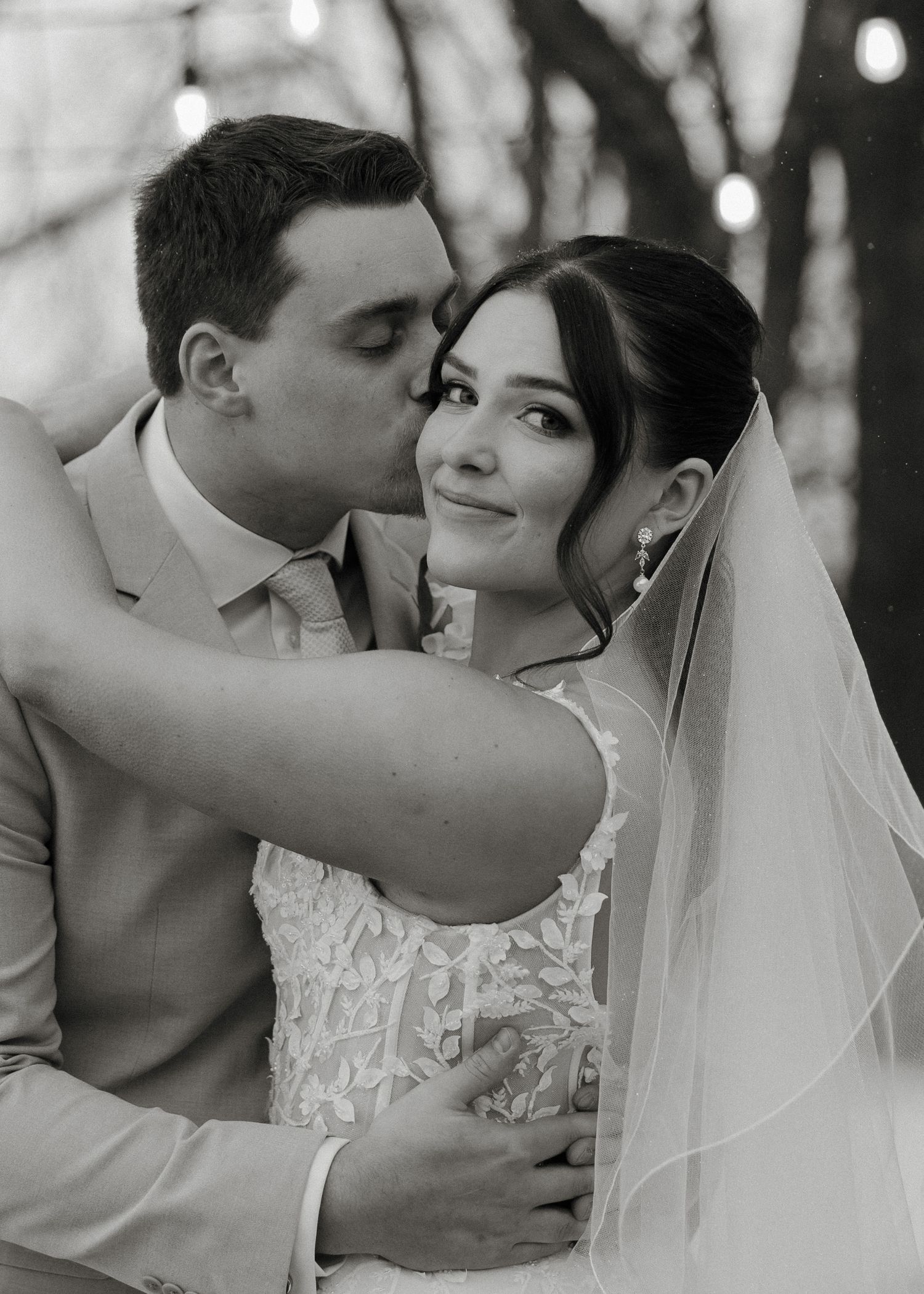 Black and white wedding photo collage showing tender moments between a bride and groom in romantic poses.