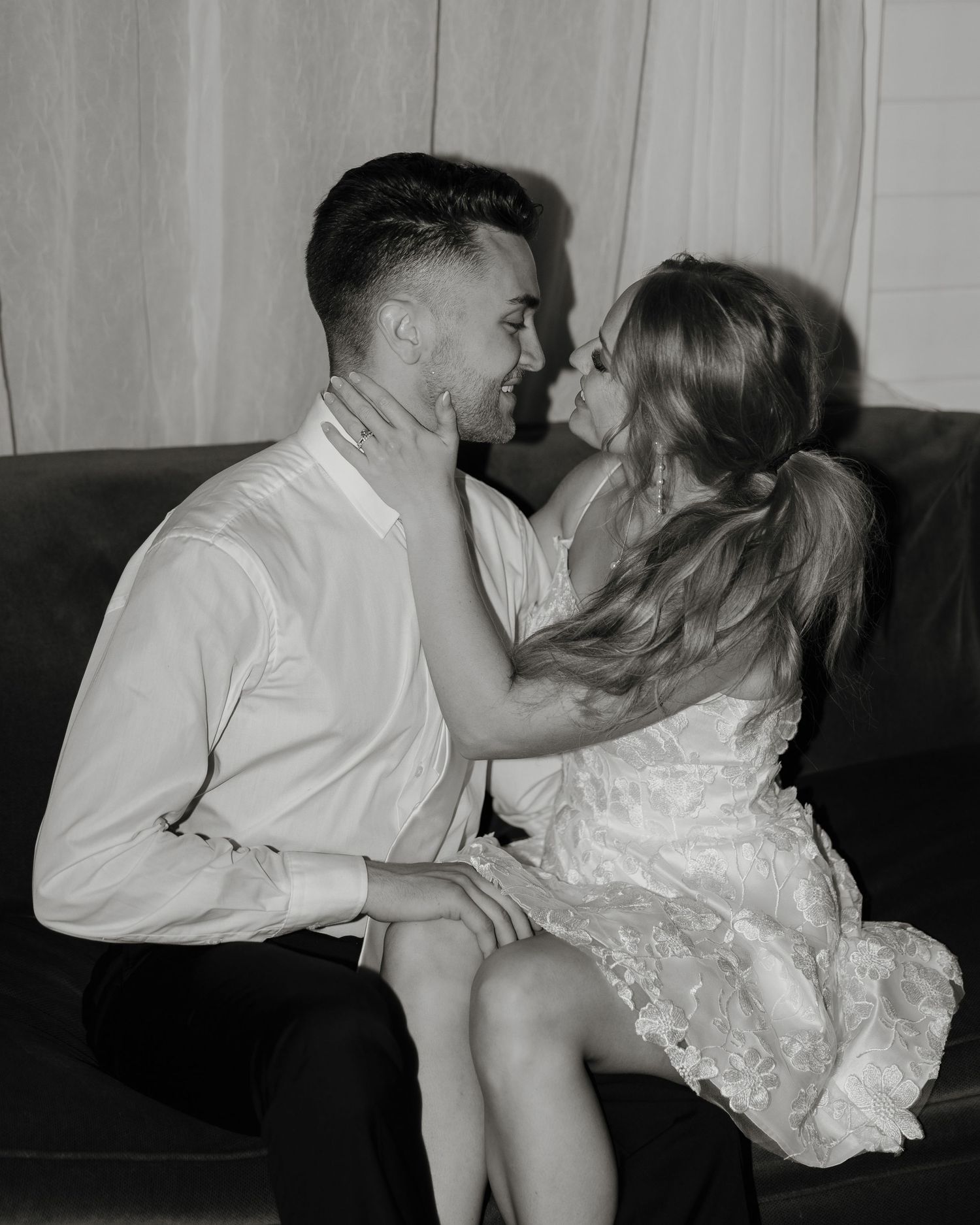 A series of black and white photographs showing a couple sharing intimate kisses on a couch.