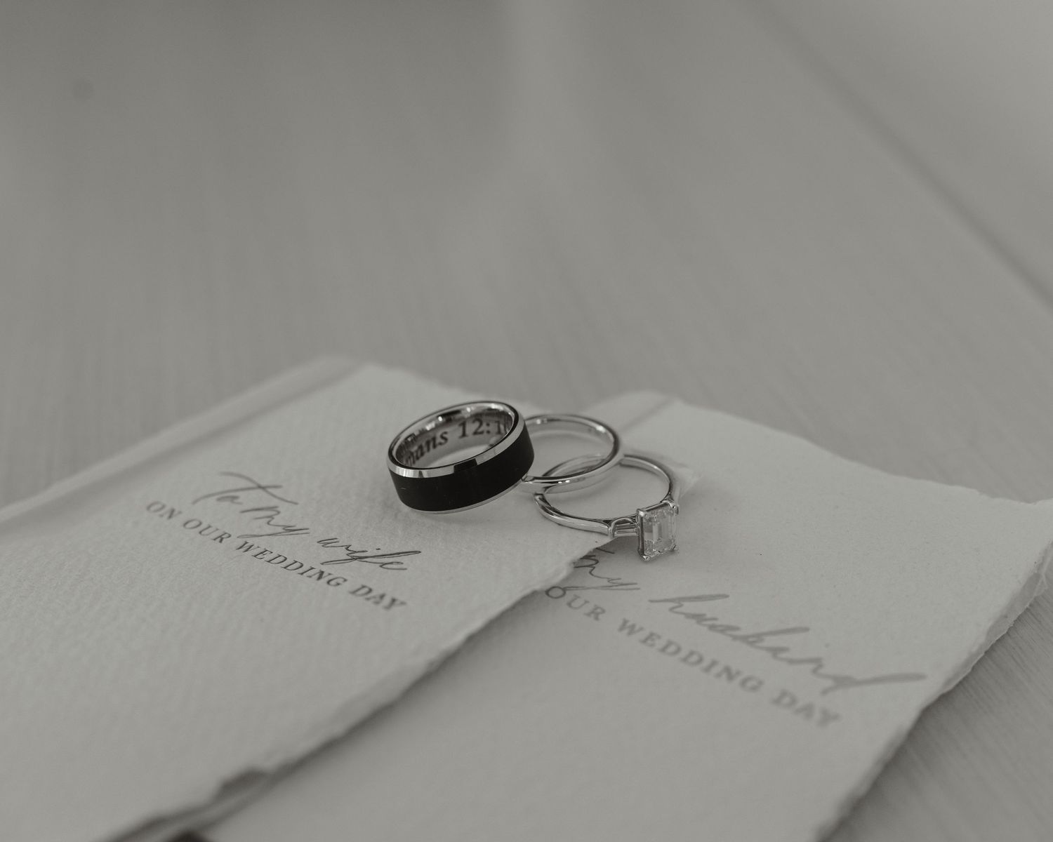A series of vintage-style black and white photographs showing open books and documents laid out on a flat surface.