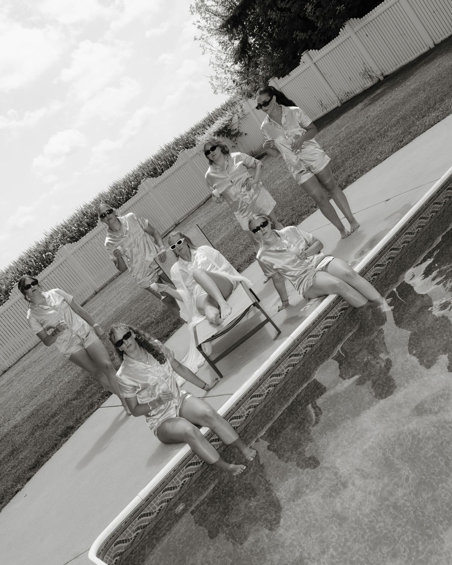 A sequence of black and white photos showing children playing on playground equipment in a park setting.