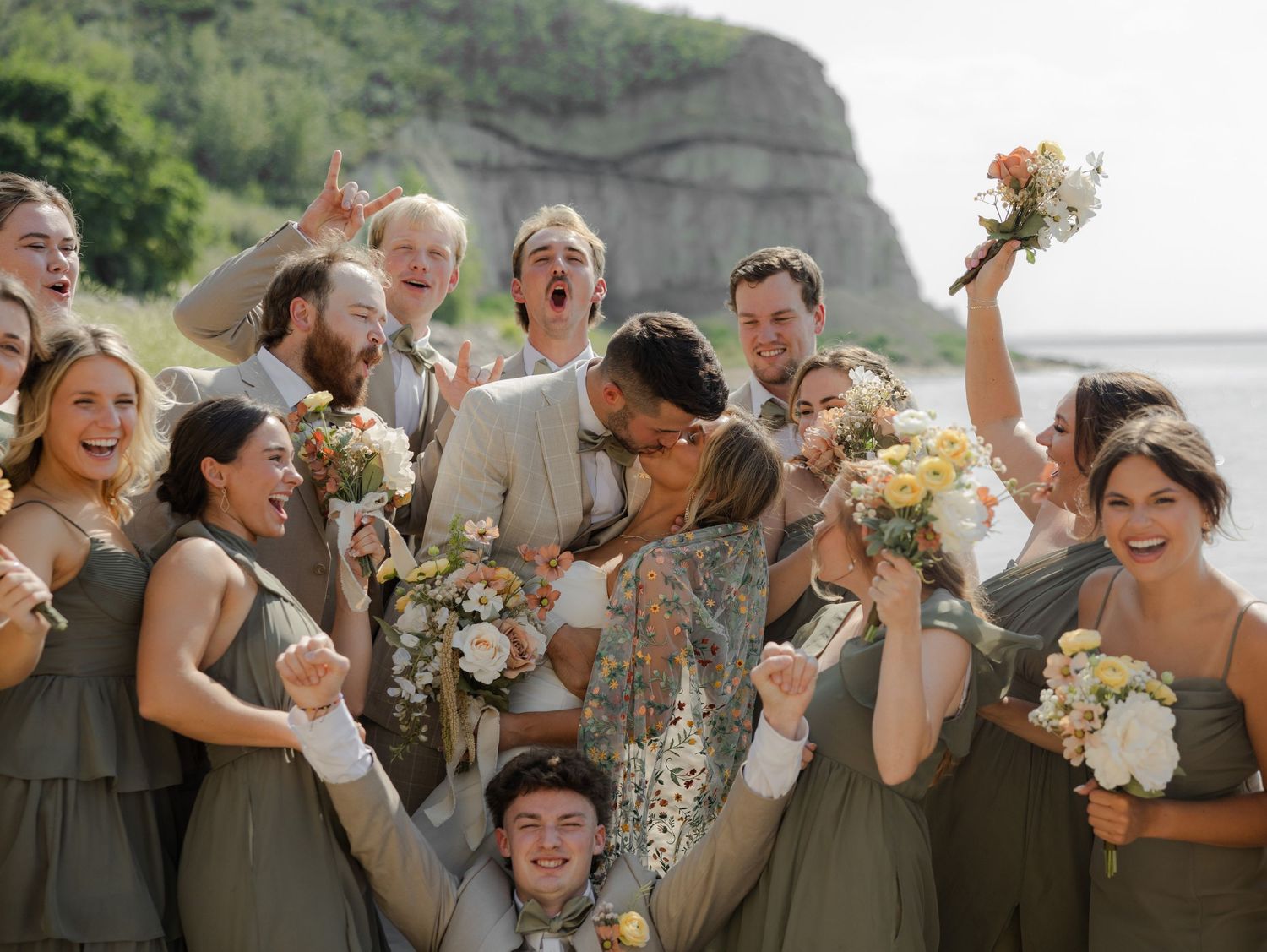 Wedding party celebrating with joyful expressions and floral bouquets.
