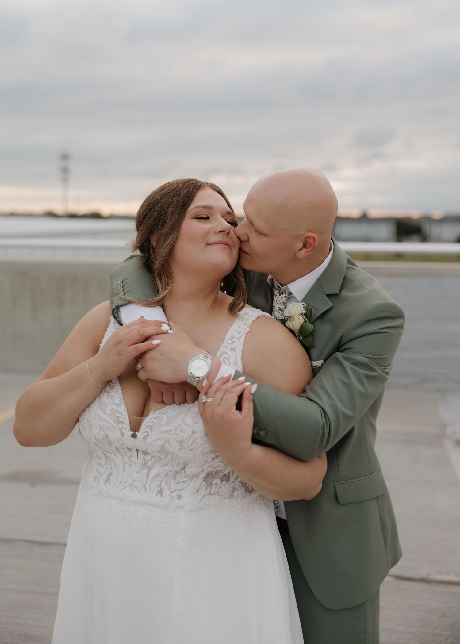 A romantic couple shares intimate moments in a series of wedding photos taken on an overcast day at an outdoor venue.
