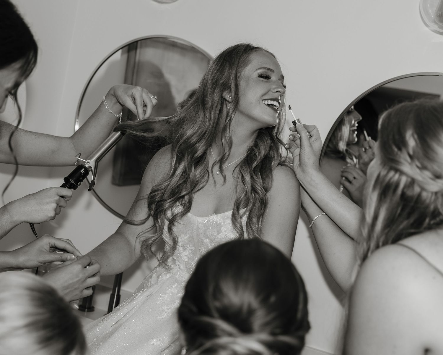 A series of black and white candid photos showing joyful laughter and celebration.